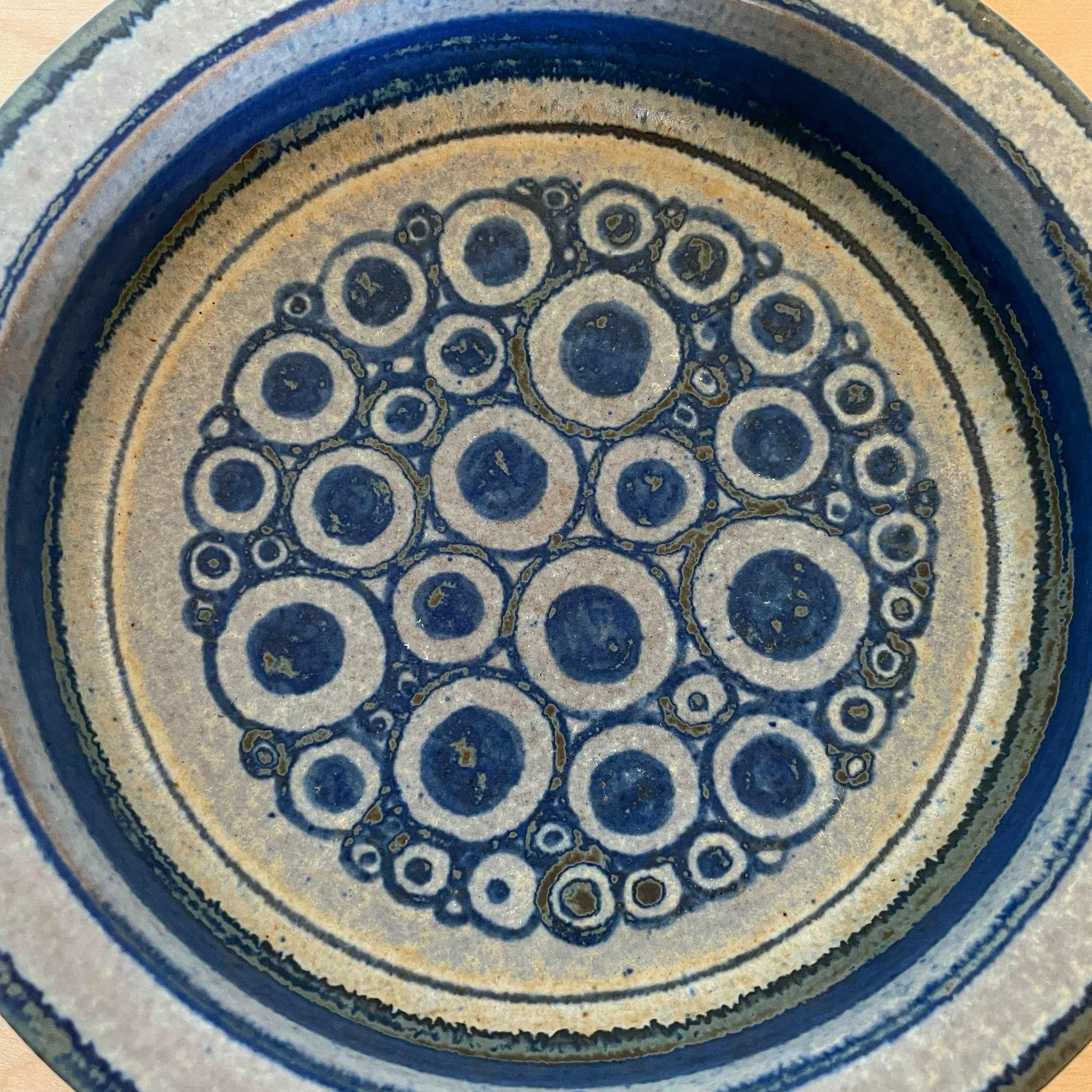 Hand painted blue and gray ceramic bowl by Marianne Starck for Michael Andersen and Son. Michael Andersen and Son was founded in the 1880s on the island of Bornholm, Denmark. Starck was lead Ceramicist and Artistic Director from 1955 until its