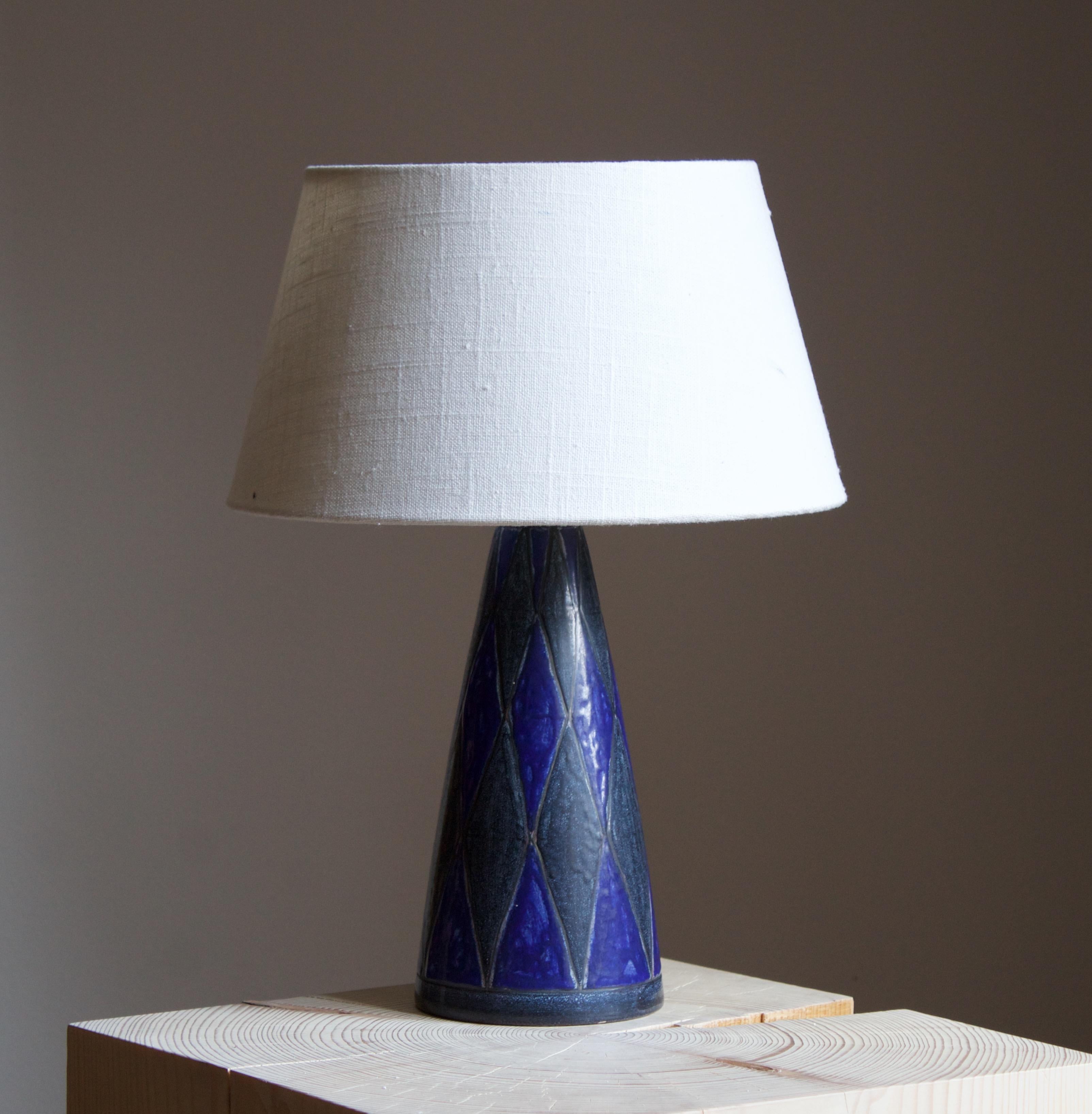 A table lamp designed by Marianne Starck produced by Michael Andersen Keramik. Signed and stamped

Purchase excludes lampshade. Stated measurements excluding lampshade. Height includes socket.

Other ceramicists of the period include Axel Salto,