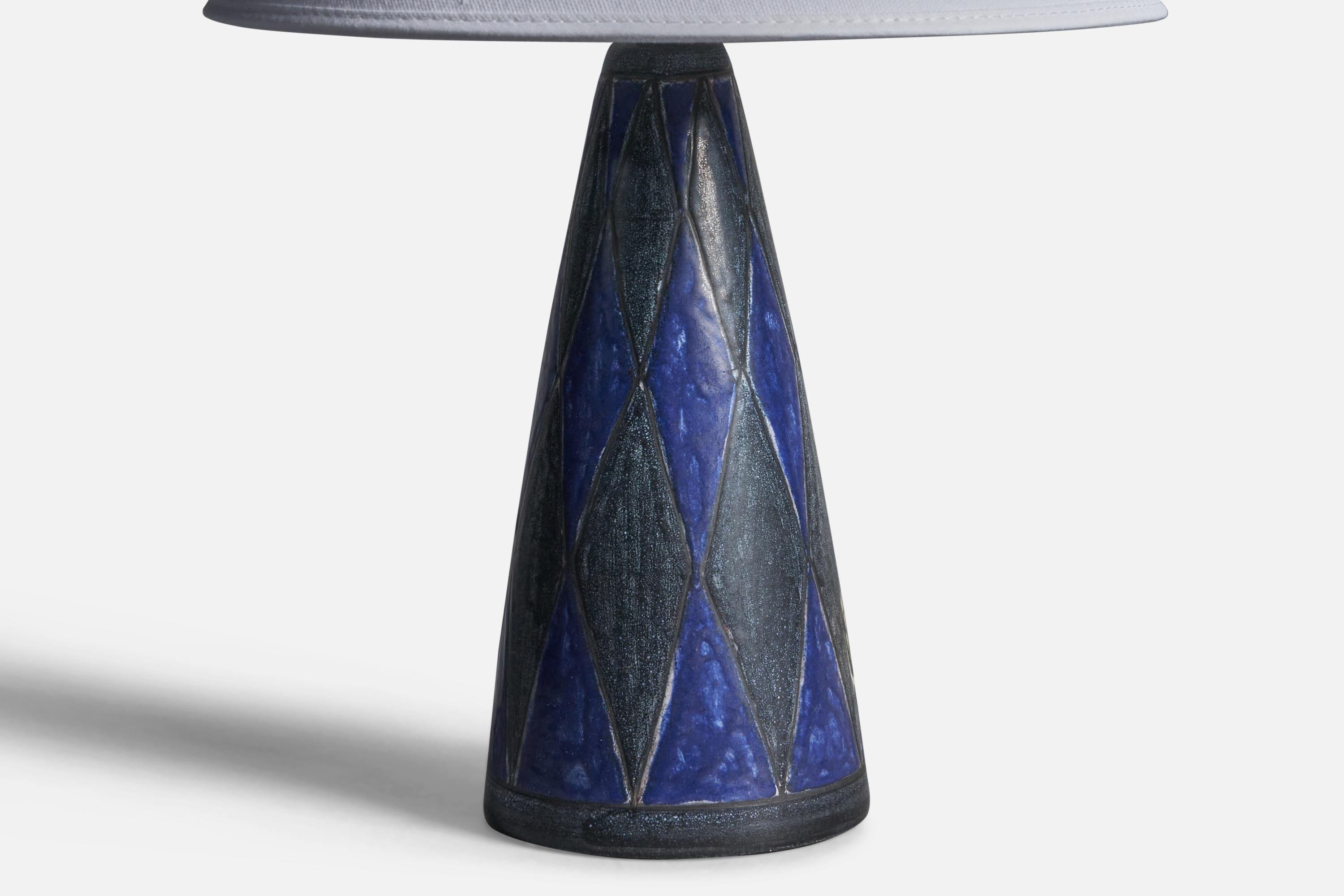 A blue-glazed stoneware table lamp designed by Marianne Starck and produced by Michael Andersen, Bornholm, Denmark, 1960s.

Dimensions of Lamp (inches): 10.75