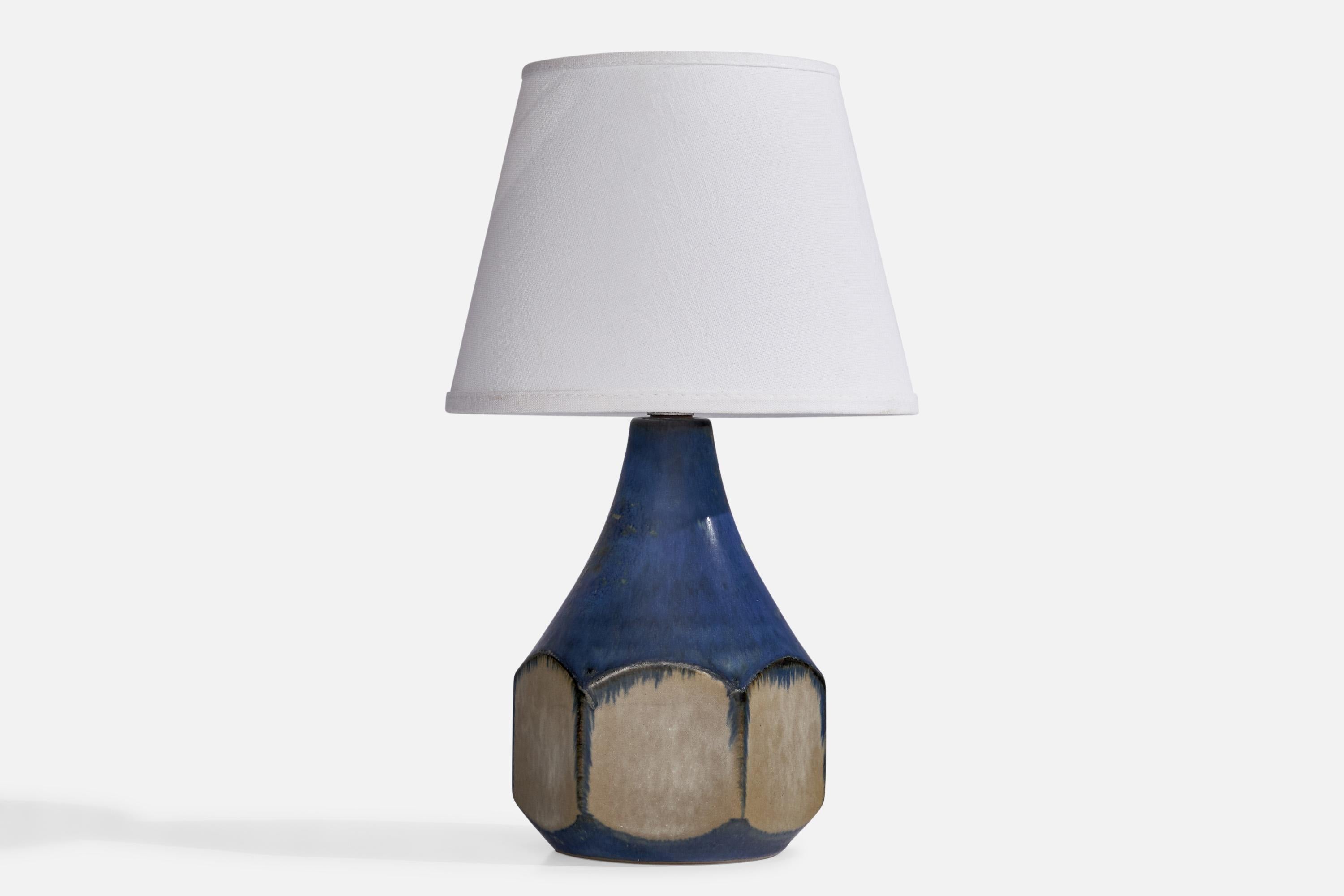 A blue-glazed stoneware table lamp designed by Marianne Starck and produced by Michael Andersen, Bornholm, Denmark, 1960s.

Dimensions of Lamp (inches): 9.5” H x 5” Diameter
Dimensions of Shade (inches): 5.25” Top Diameter x 8” Bottom Diameter x 6”