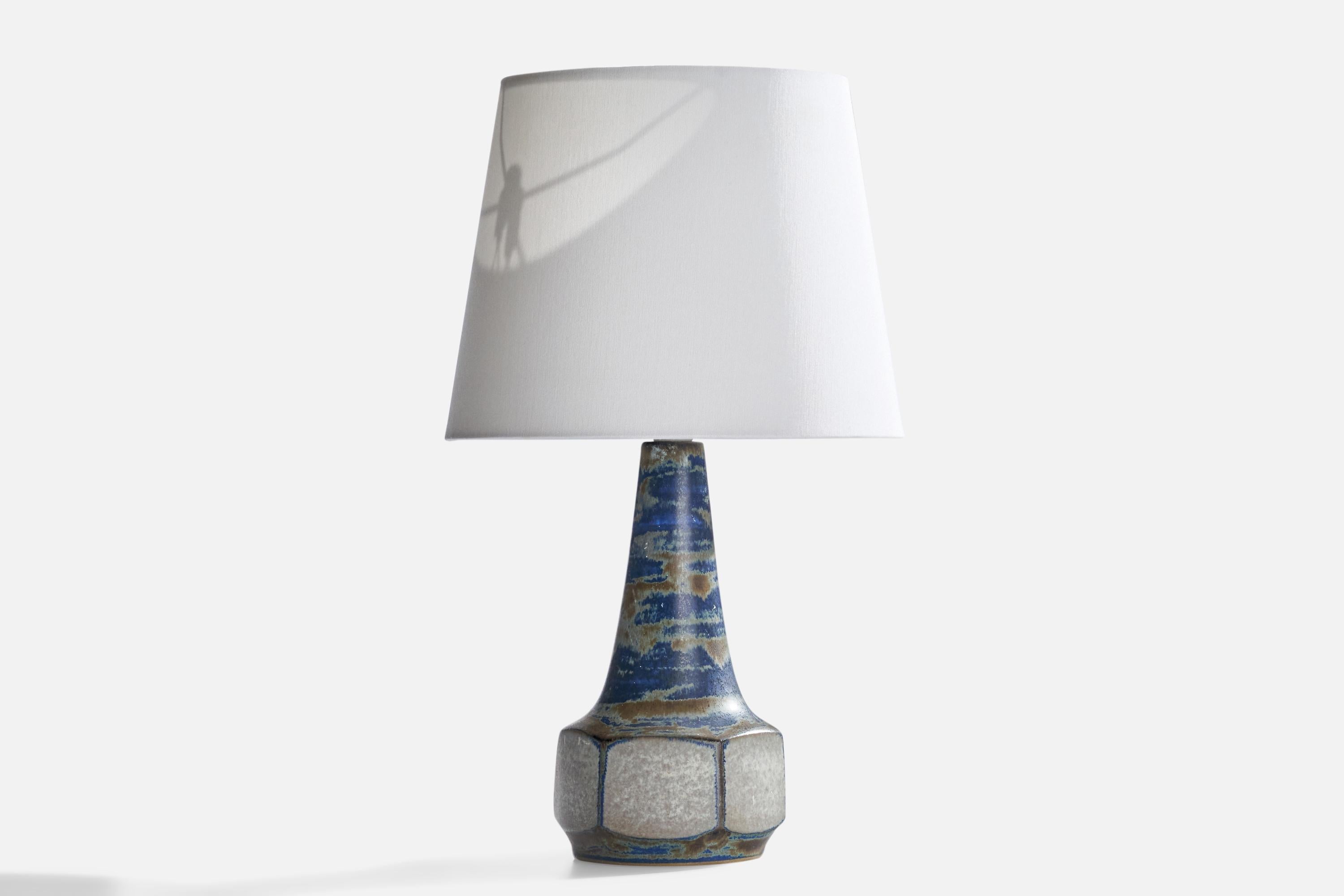 A blue-glazed stoneware table lamp designed by Marianne Starck and produced by Michael Andersen, Bornholm, Denmark, 1960s.

Dimensions of Lamp (inches): 11.25” H x 5” Diameter
Dimensions of Shade (inches): 4” Top Diameter x 10”  Bottom Diameter x 8”
