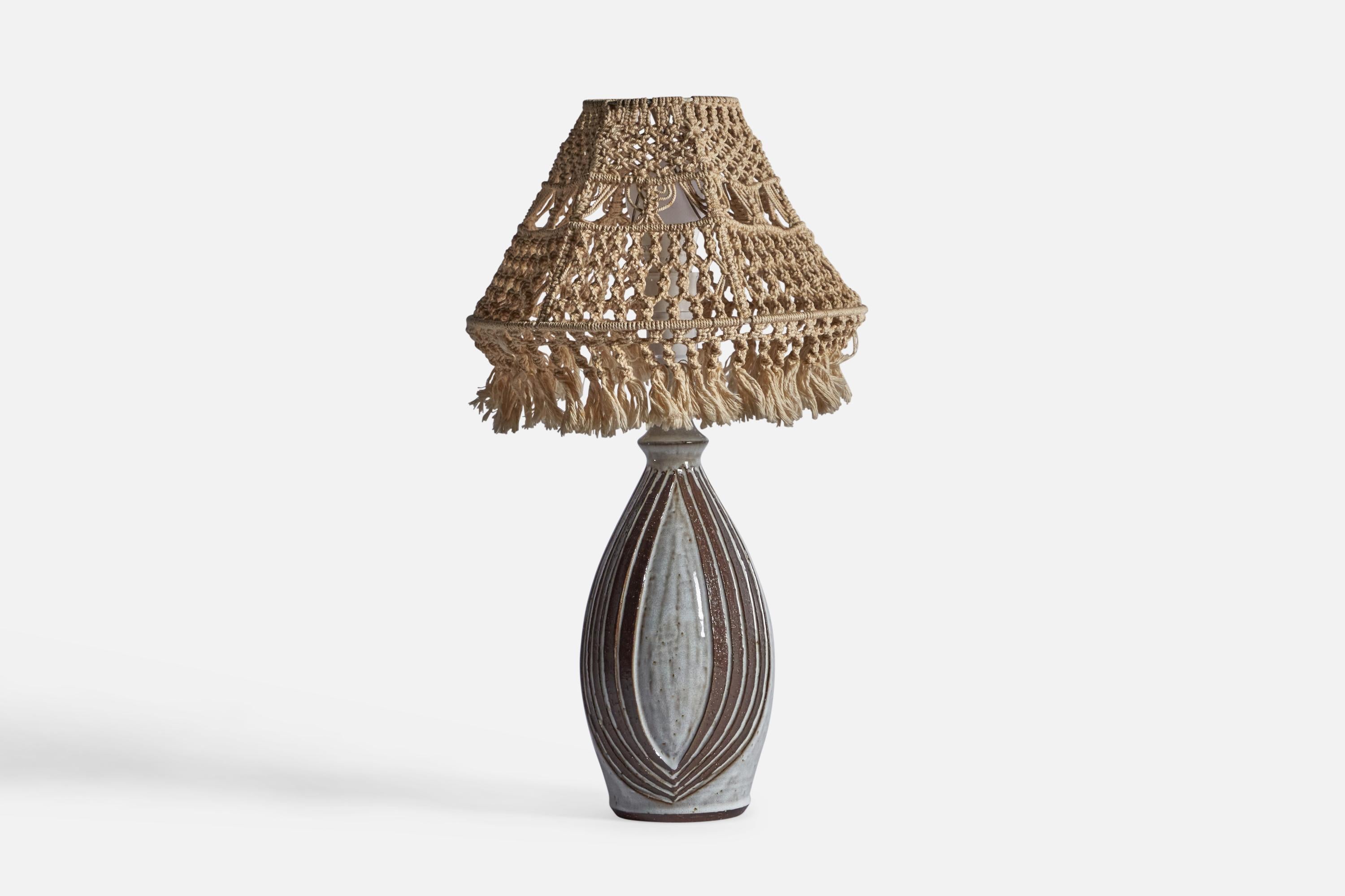 A grey-glazed and woven fabric table lamp, designed by Marianne Starck and produced by Michael Andersen, Bornholm, Denmark, 1960s.

Sold with Lampshade.

Dimensions stated are of Table Lamp with Lampshade attached.