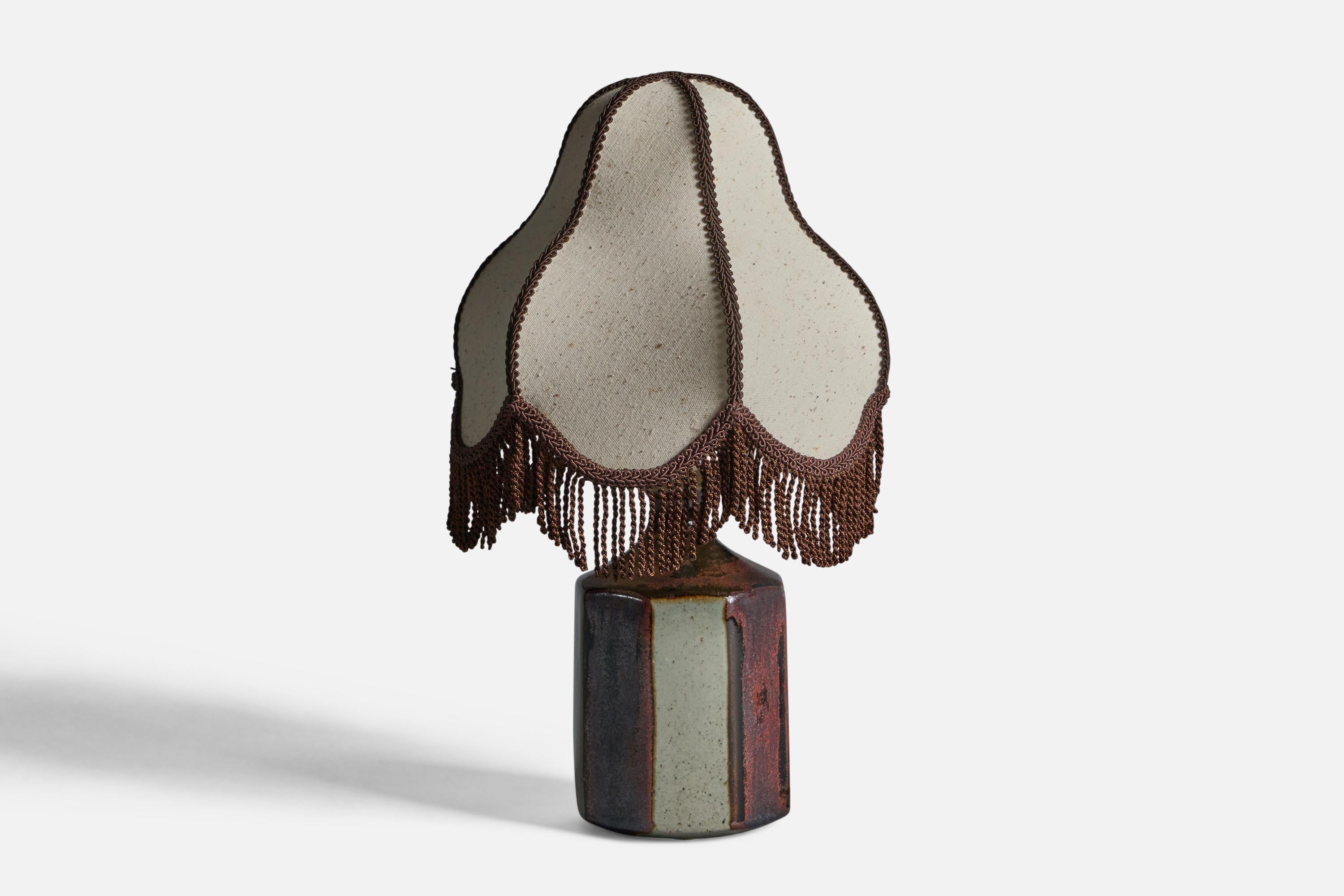 A red and light-grey glazed stoneware and grey brown fabric table lamp, designed by Marianne Starck and produced by Michael Andersen, Bornholm, Denmark, 1960s.

Overall Dimensions (inches): 14.5