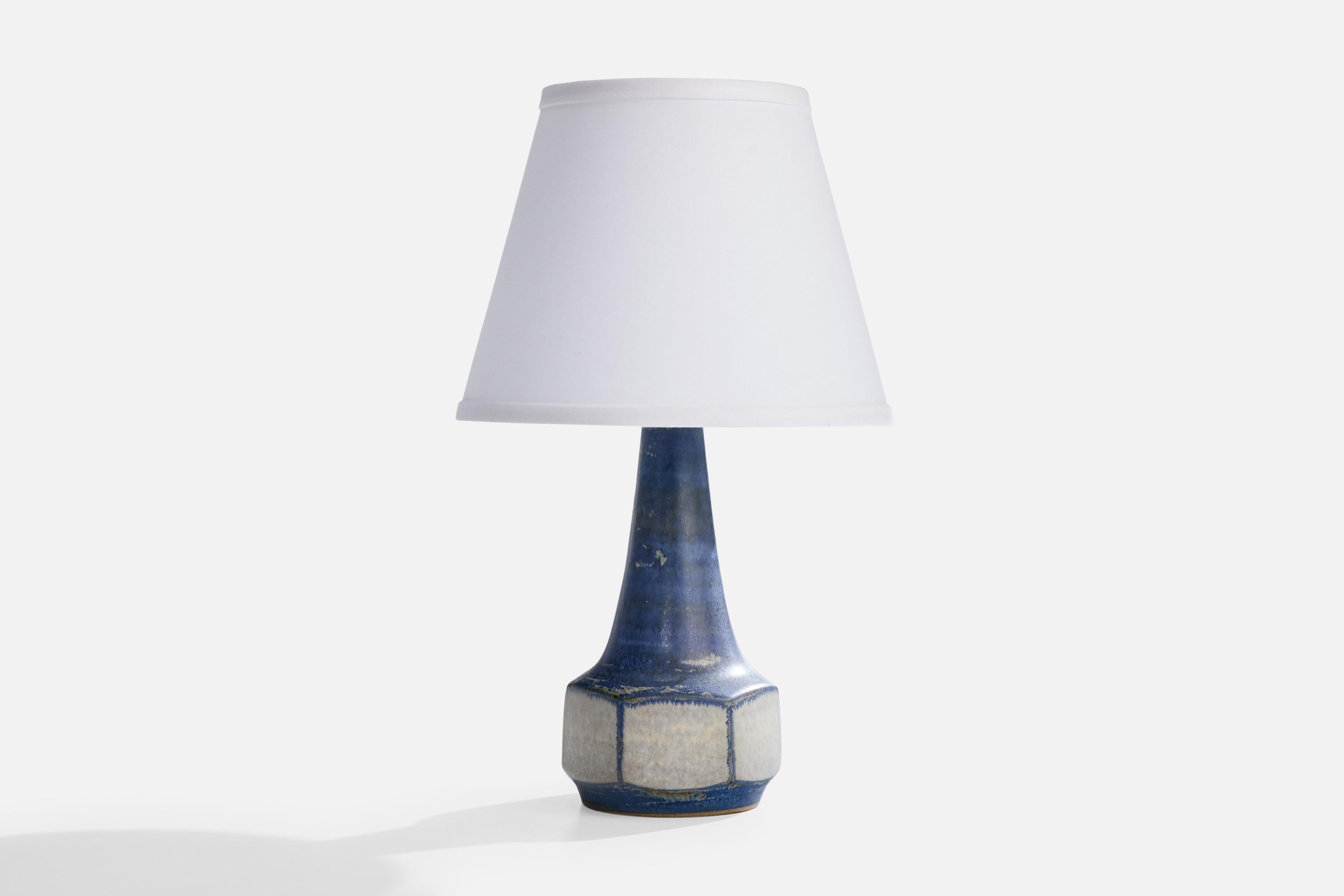 A blue and grey-glazed stoneware table lamp designed by Marianne Starck and produced by Michael Andersen, Bornholm, Denmark, 1960s.

Dimensions of Shade (inches): 6” Top Diameter x 10” Bottom Diameter x 8” Height

Dimensions of Lamp with Shade