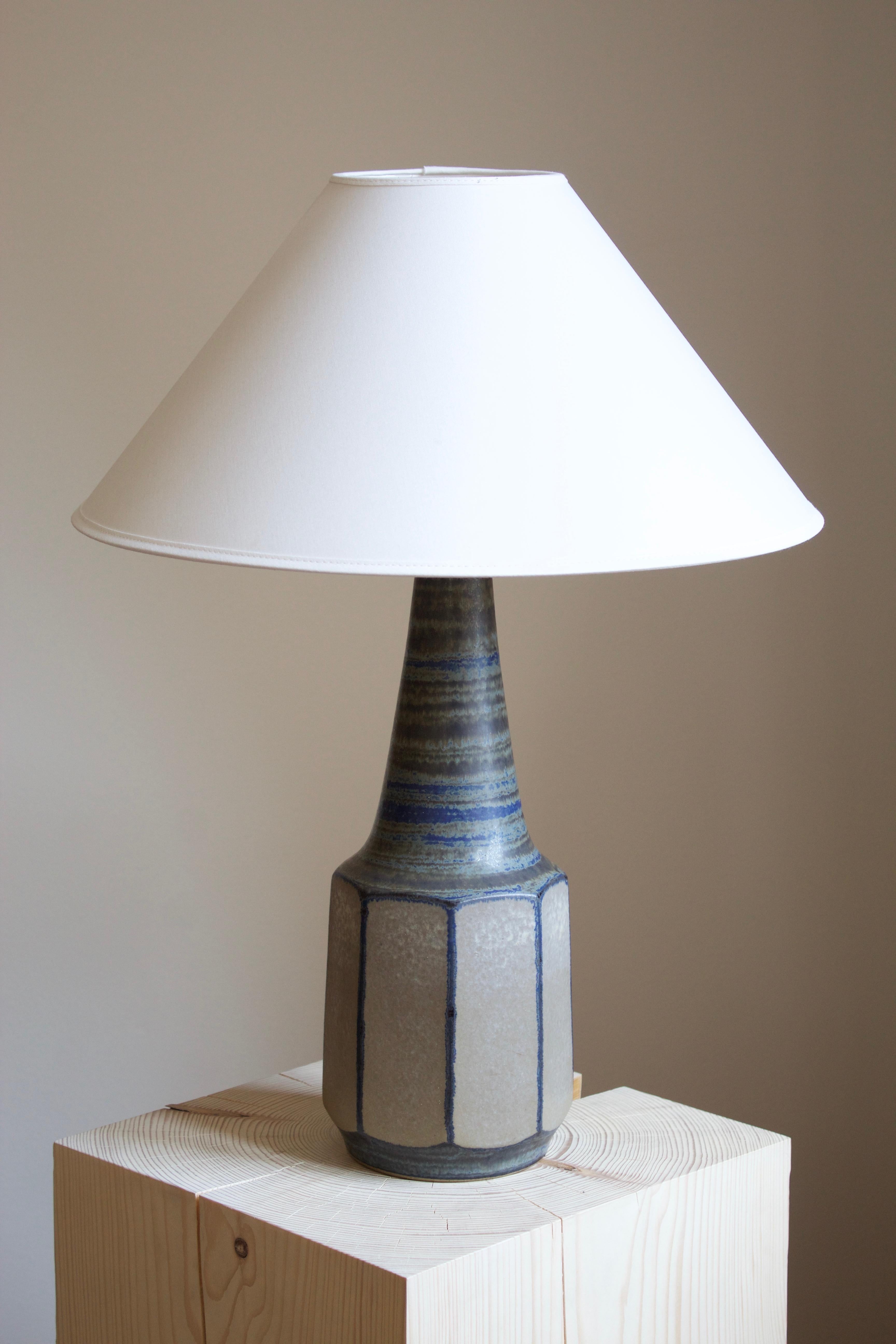 A table lamp designed by Marianne Starck produced by Michael Andersen Keramik. Handpainted.

Purchase excludes lampshade. Stated measurements excluding lampshade.

Glaze features grey-blue-brown colors.

Other ceramicists of the period include Axel