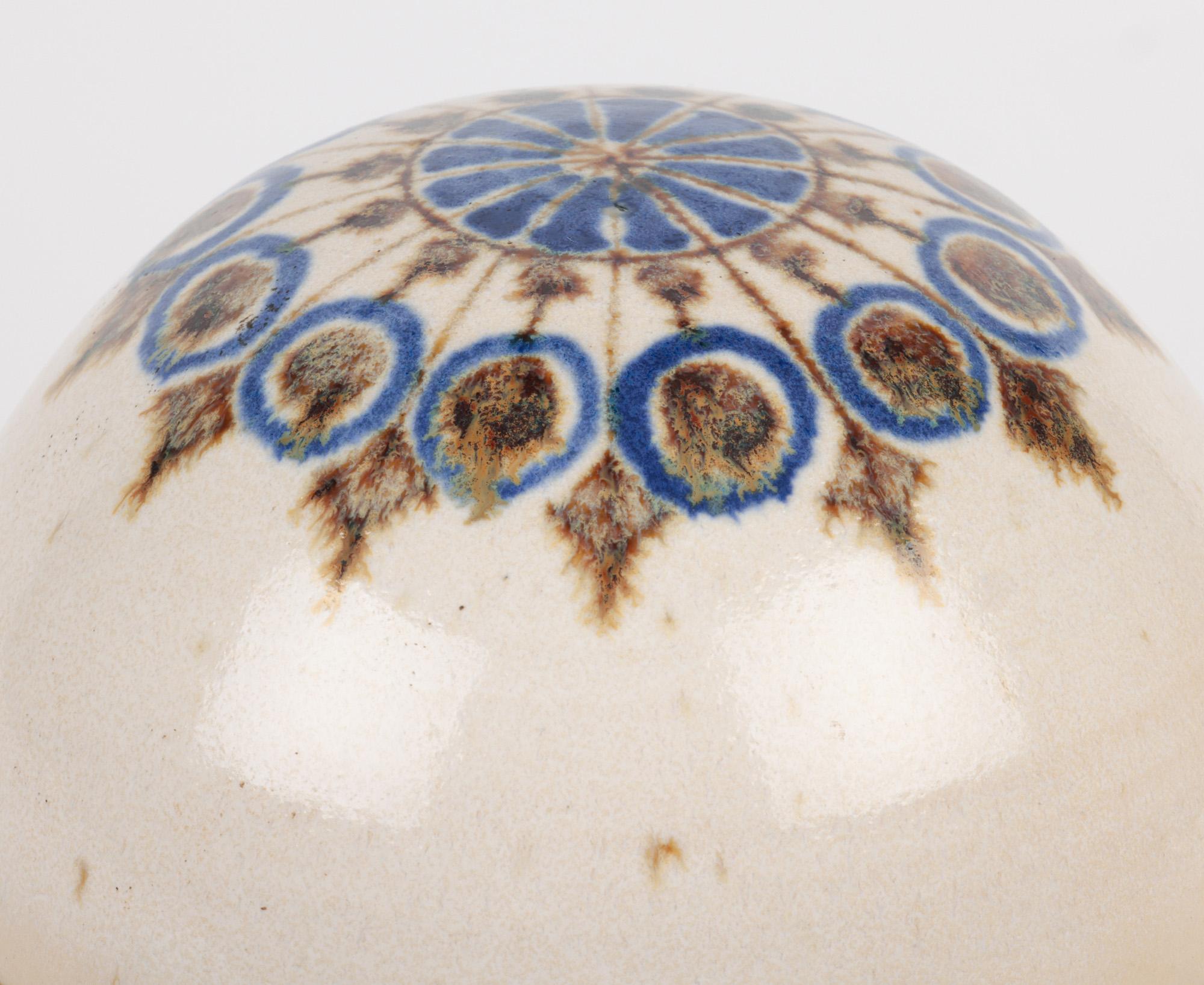 A superb vintage Danish studio pottery lidded pot designed by Marianne Stark for Michael Andersen & Son around 1970. The Borholmsk Keramik stoneware pot is of heavy rounded shape standing raised on a narrow short round foot rim with a ridged upper