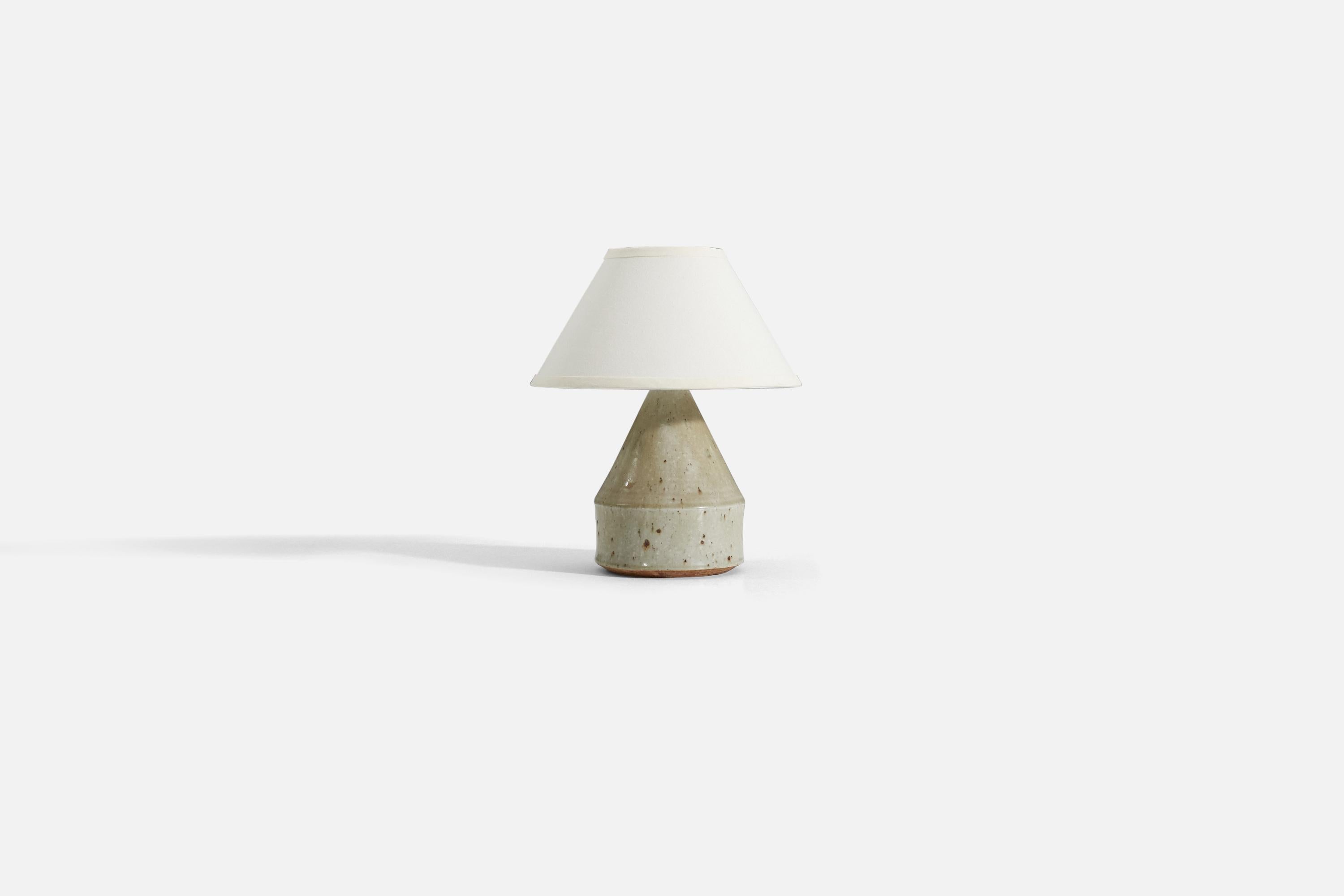 A table lamp in grey-glazed firesand designed by Marianne Westman for Rörstrand, Sweden, 1960s. Signed and marked to underside.

Stated dimensions exclude lampshade. Lampshade is not included in purchase.
For reference:
Measurements of shade : 5