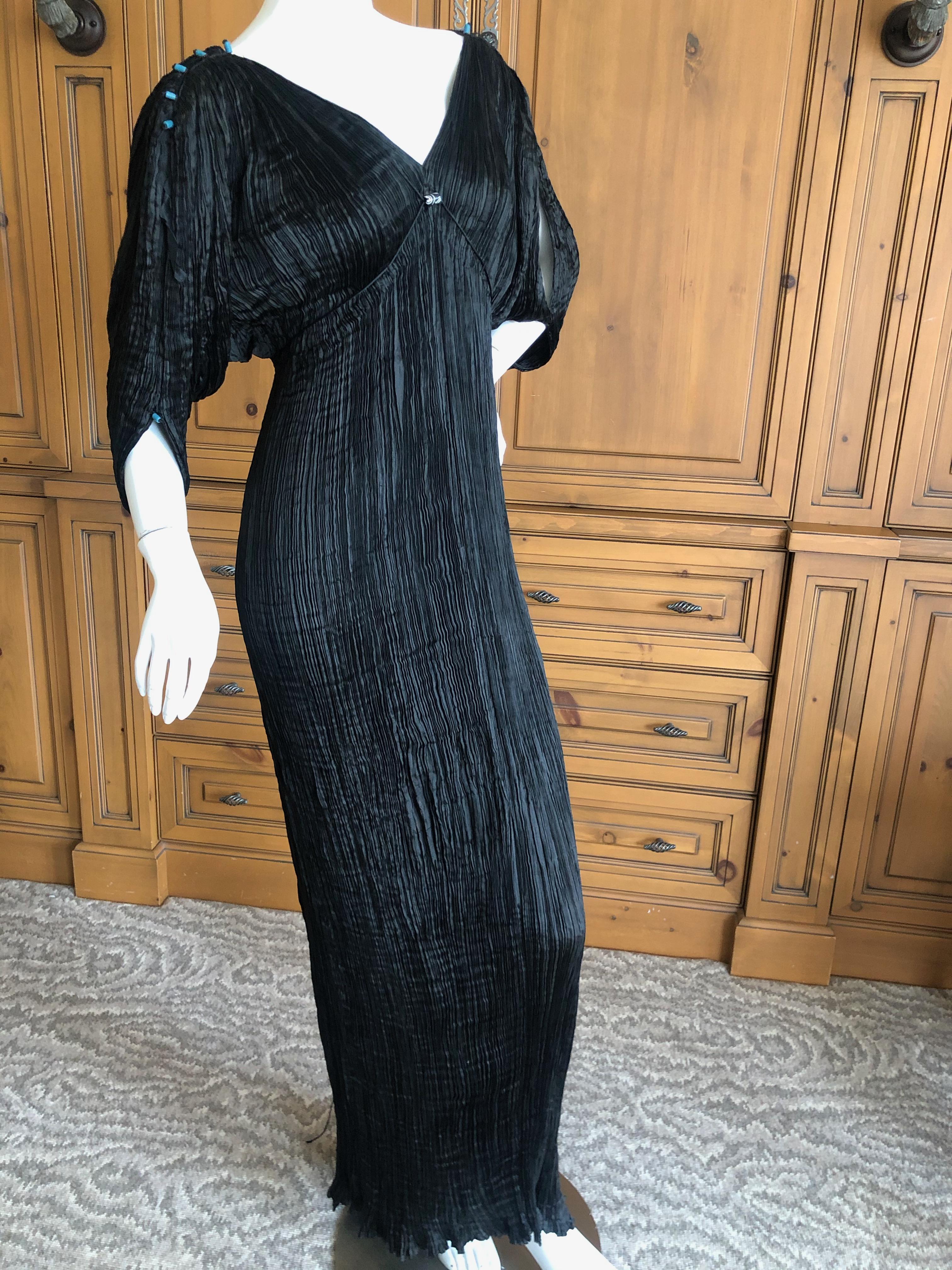 Mariano Fortuny Black Delphos Dress
Mariano Fortuny revolutionized fashion when he eliminated the corset and designed the pleated Delphos gown to be worn without restrictive undergarments.
Created by a secret pleating method and constructed with