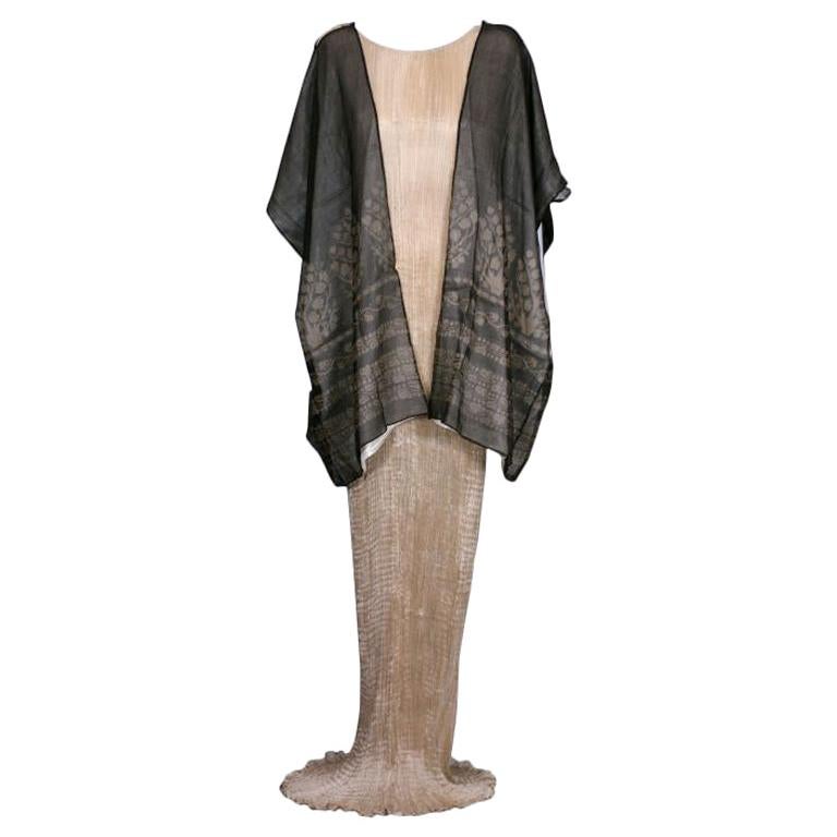Fortuny translated the caftan as a loose fitting outer garment, usually made out of silk velvet crepe or gauze the fitted back and open front allowed for elaborate stenciled decoration and  venetian bead trim .Mariano Fortuny created his stenciled