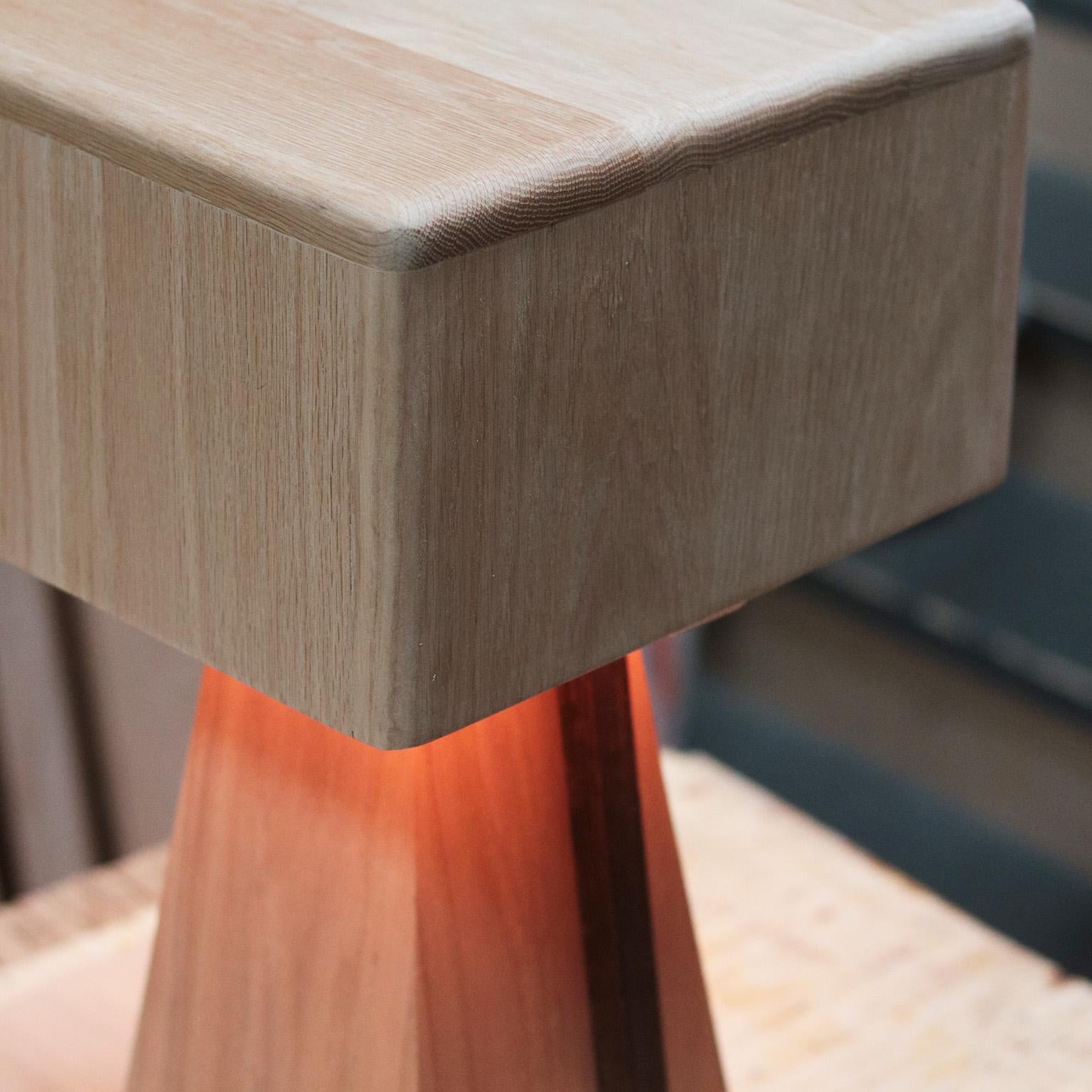 The Marici lamp features an elegant and sculptural silhouette.  The solid wood shade cascades an ethereal glow, emanating a gentle golden light that reflects off the body of the lamp.  The design is monolithic and angular, crafted entirely of solid