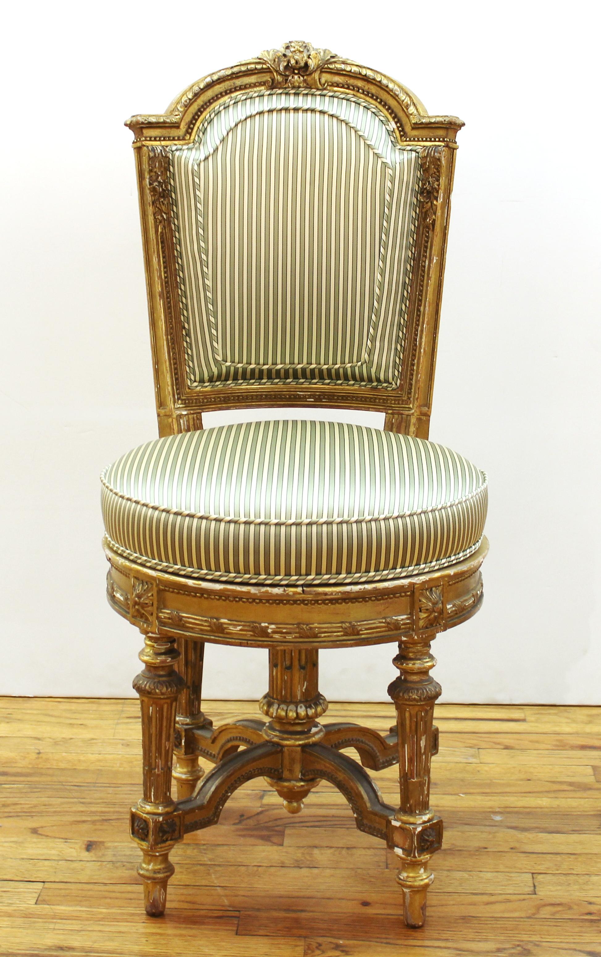 French Marie-Antoinette style giltwood boudoir chair with upholstered swiveling seat and back. Late 19th century. Measures: 36.5