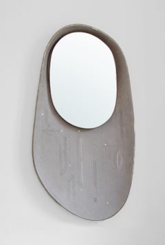 Oval mirror inlayed in grey sculpted leather with copper and gold detailing