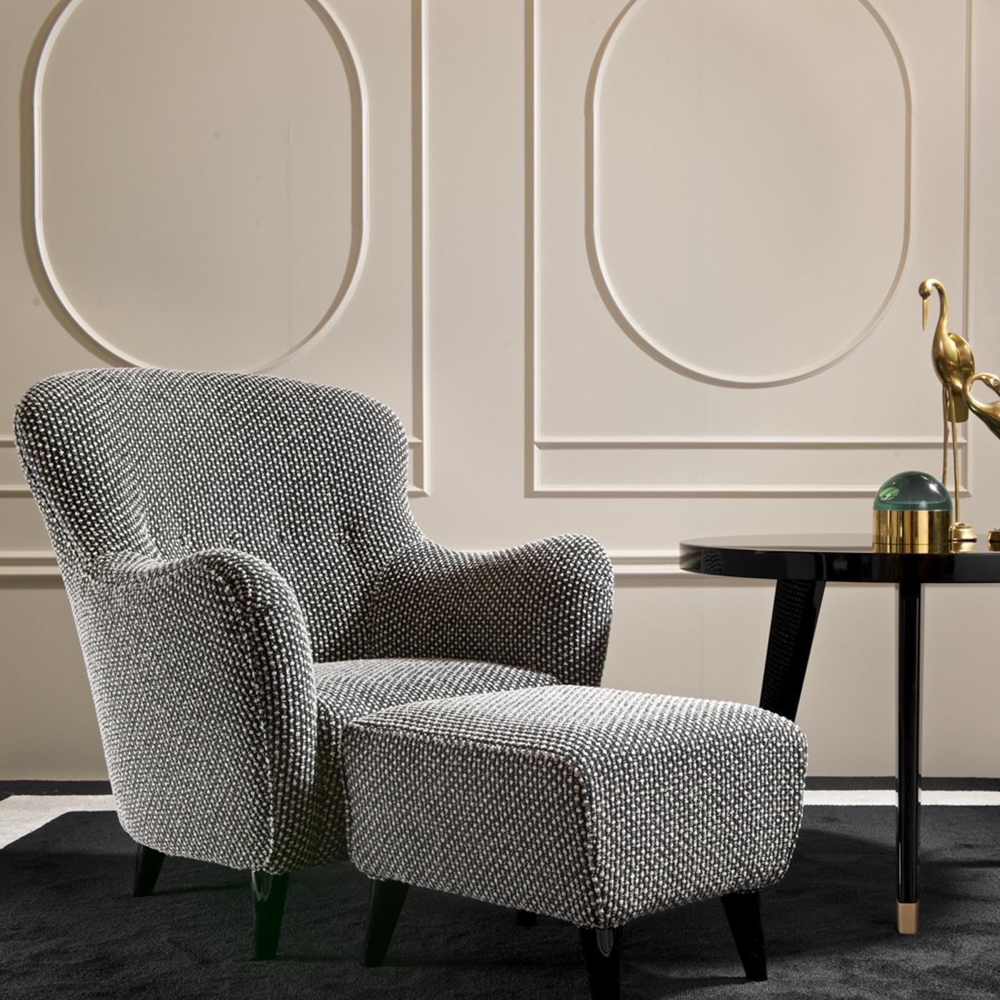 Merging classic lines with modern flair, this pouf can be used as a statement piece in a modern living room or bedroom, or combined with the Marie Armchair to infuse a glamorous look into a living room or office. Raised on four black-lacquered legs