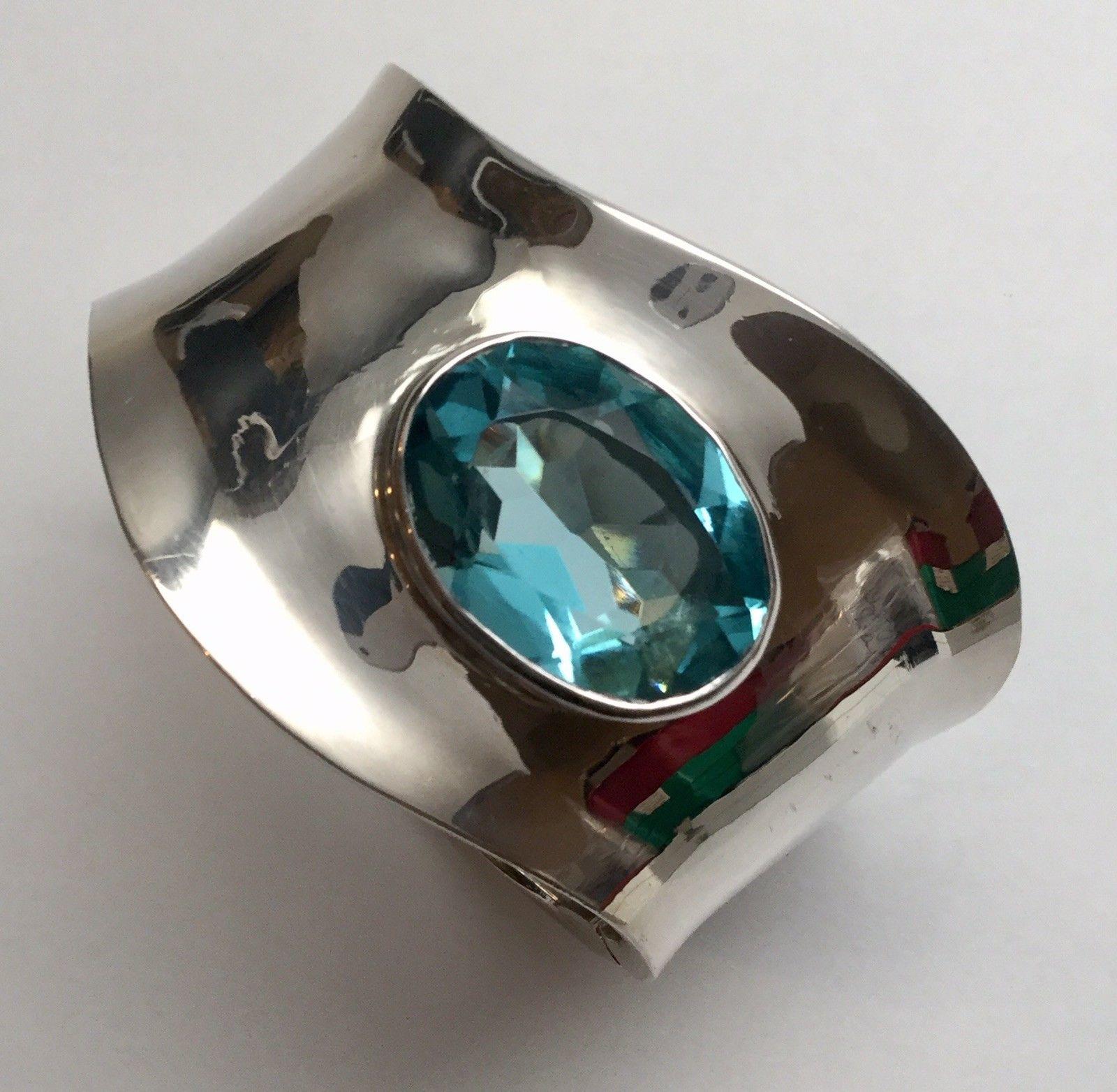 Maria Elena Munoz Mexico sterling silver blue topaz clamper bracelet.

Marked: mem ma.elena munoz MEXICO 925

Measures: 7 1/4