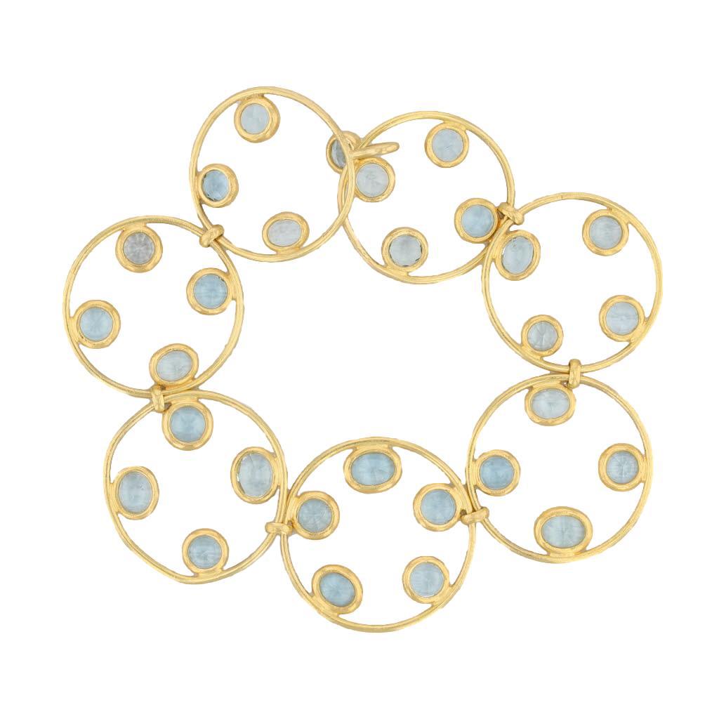 This gorgeous designer bracelet is a Marie-Helene de Taillac piece. The elegant chain is composed of linked, open gold circles accented by bubbles of genuine aquamarine gems. The aquas have a lovely, vibrant coloring complimenting the yellow gold