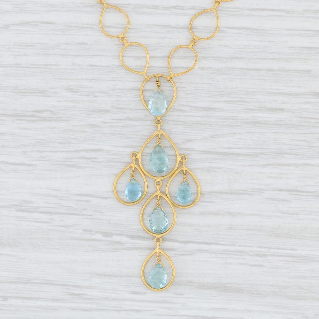 This beautiful necklace is a Marie Helene de Taillac designer piece. The necklace is composed of teardrop like links with an elegant stationary drop hanging from the center. The drop is accented by aquamarine briolettes with a lovely shimmering aqua