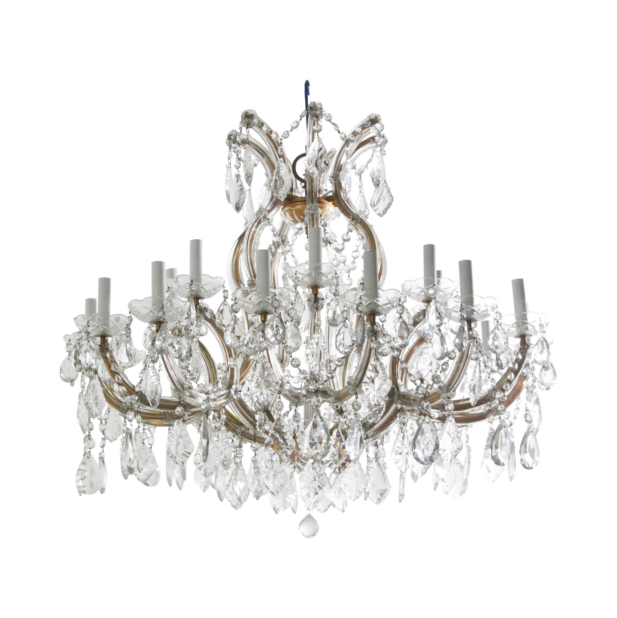 This antique Marie Therese chandelier is from the Grand Prospect Hall in Brooklyn NY. This chandelier has 22 lights mounted on white plastic sleeved candlesticks and consists of numerous crystals hanging from beautifully curved arms covered in glass