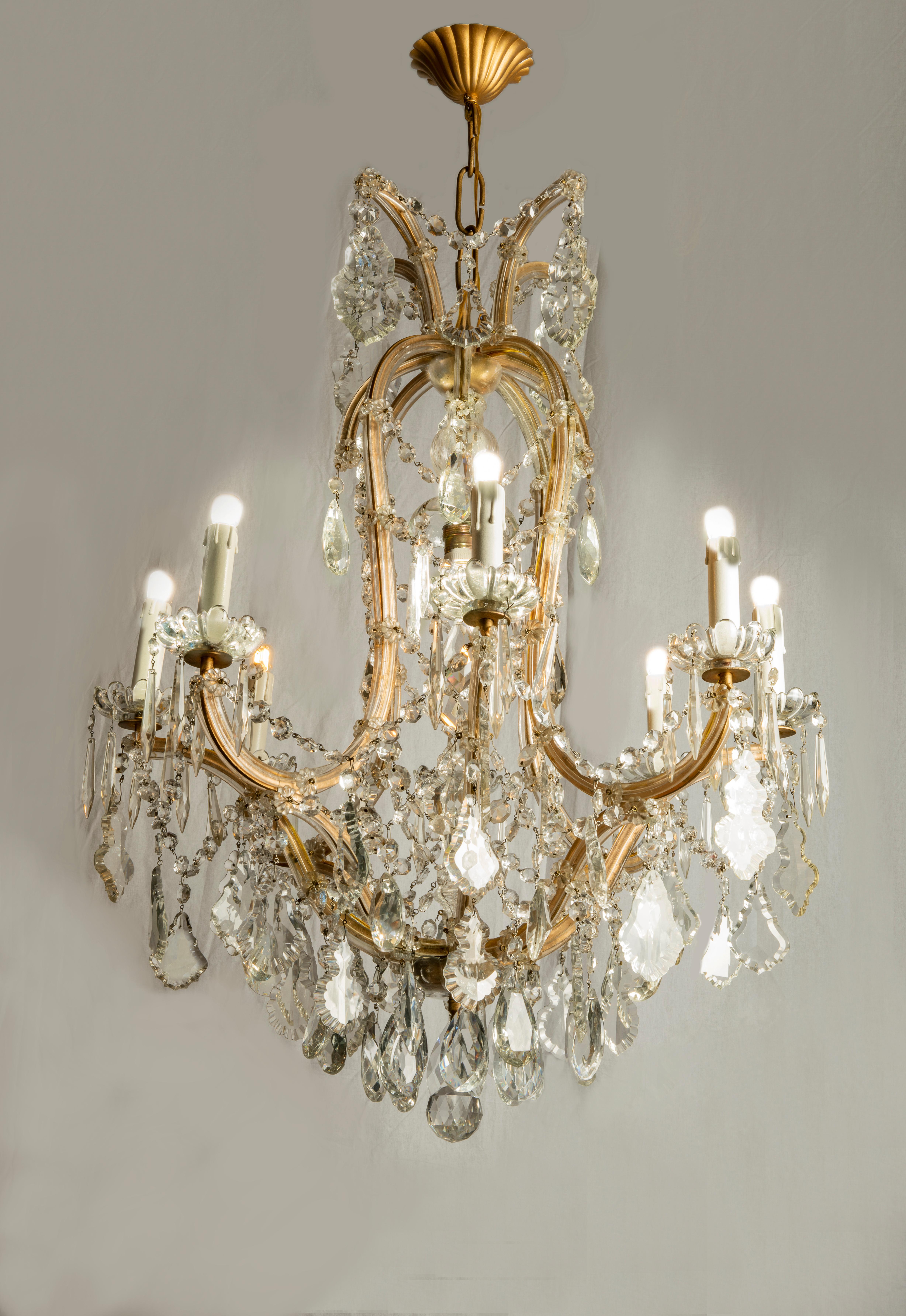 From Italy a Maria Teresa crystal chandelier fully arranged with crystal chains and drops. A  crystal nine-light chandelier with eight curved arms and one extra bulb in the upper centre of the structure. Perfect condition. New wiring for Italian