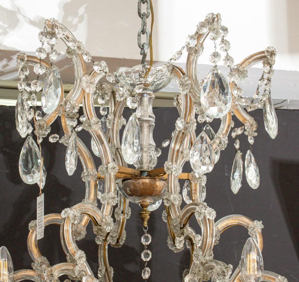Marie Therese Crystal 18 Light Chandelier, Circa 1960, with two tiers of scrolling branches with swags of cut crystal drops. 52