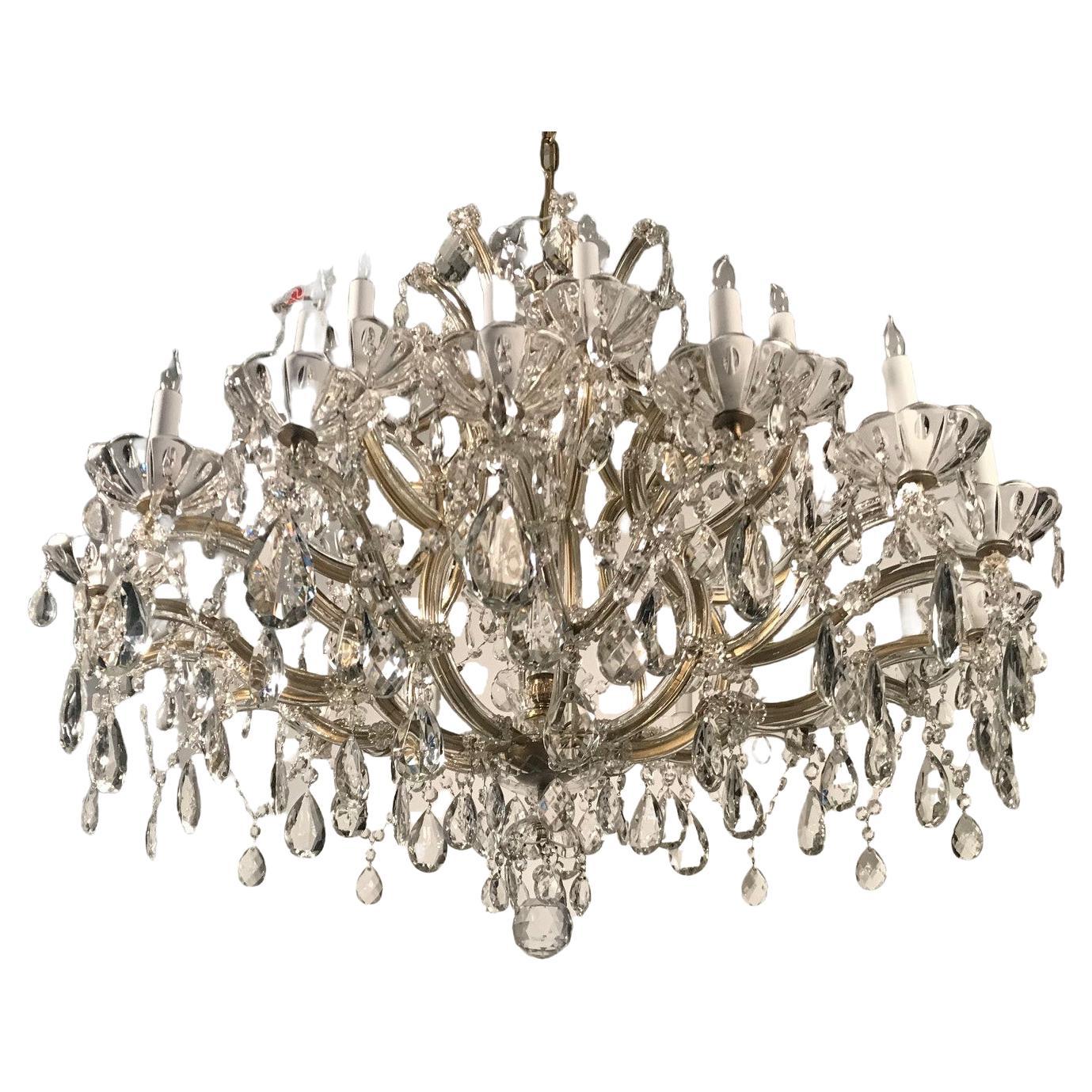 An impressive large vintage Czechoslovakian Marie-Therese style cut crystal chandelier with a shaped central body surmounted by elegant contoured scrolling arms. The whole profusely hung with drops, hanging beads and French style pendeloque