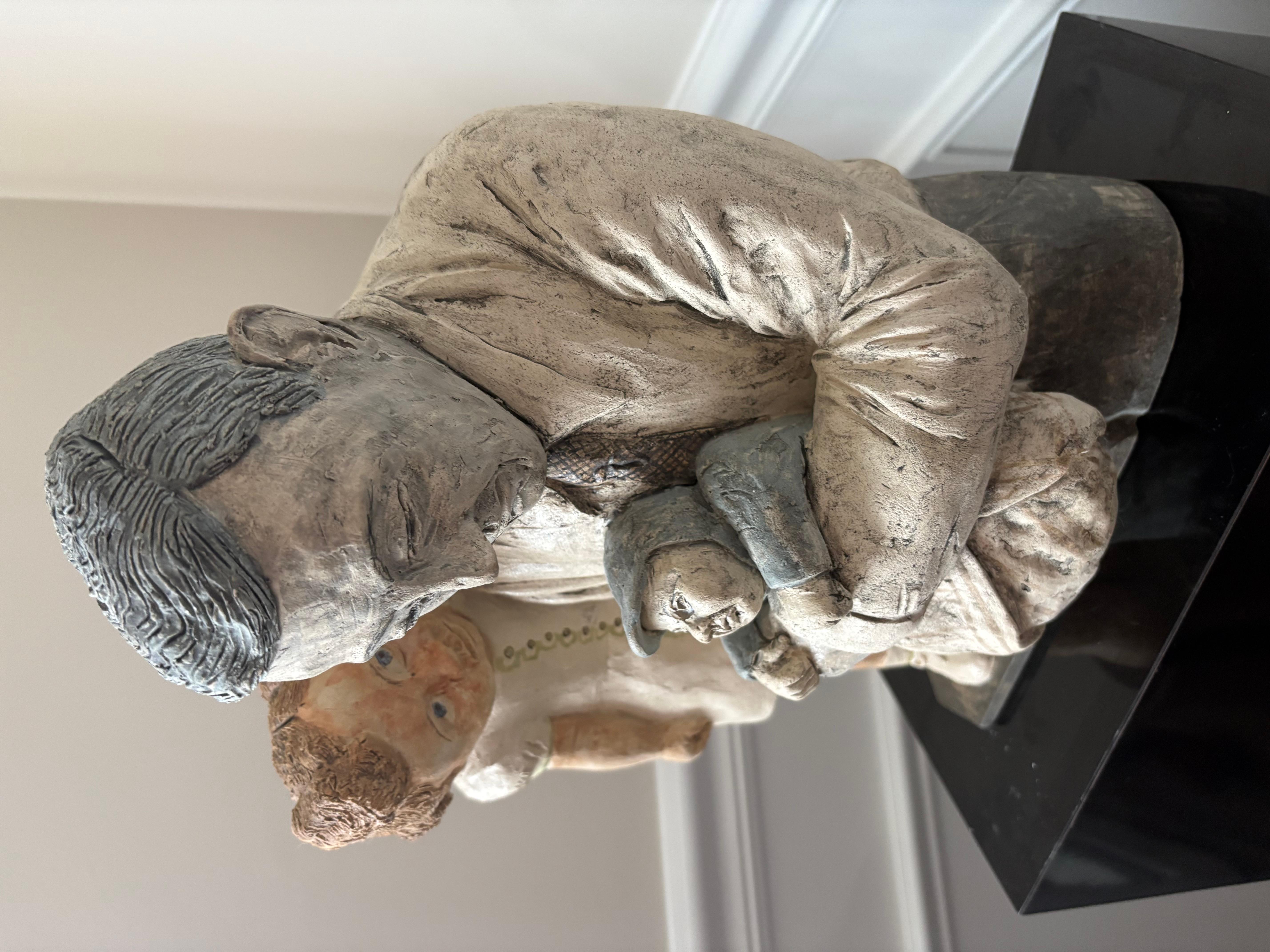Discover the serene touch of this Marilyn Andrews studio pottery sculpture, a fine art piece that captures the essence of a loving family dynamic. The meticulously crafted father and children figurine set embodies a sense of warmth and togetherness,