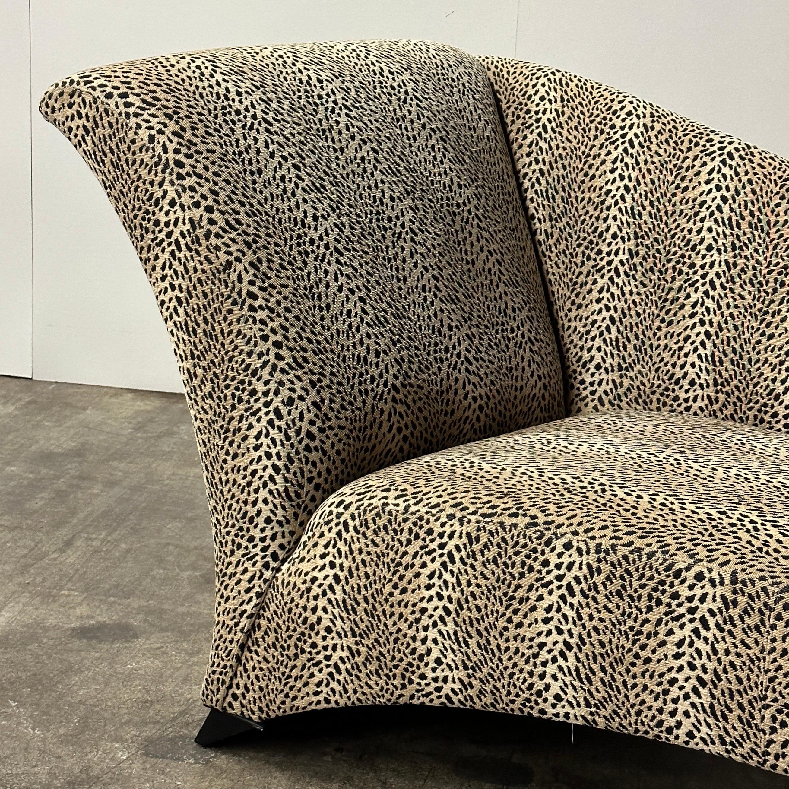 c. 1980s. Upholstered in its original leopard print fabric. Tagged. Has unique feet which are not on any other models online.