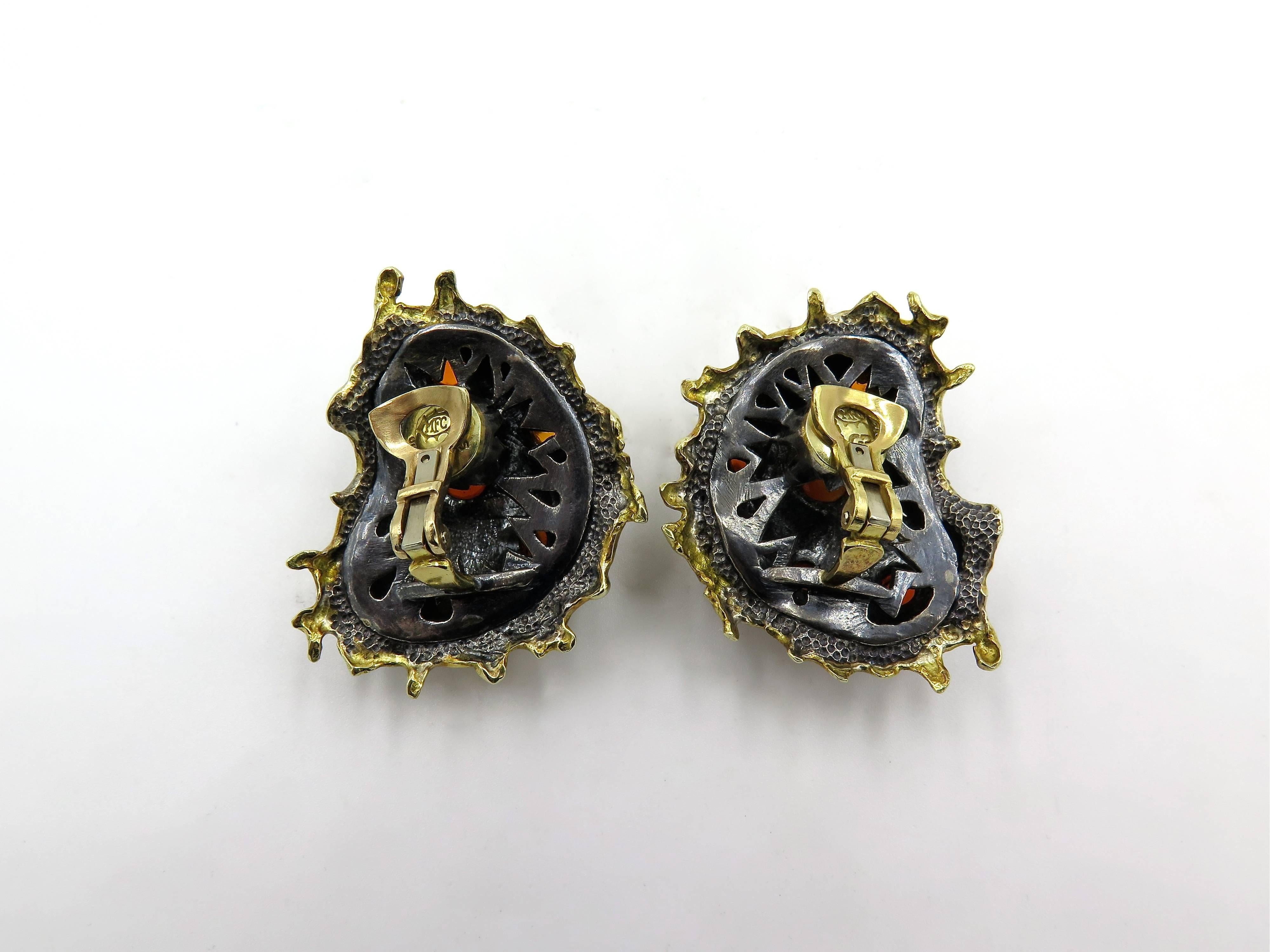A pair of 18 karat yellow gold, silver and carnelian earrings.  Marilyn Cooperman.   Circa 1990.   The earrings are known as Persimmon Salad.  Signed MFC, 925, 750 and GB.  Gross weight approximately 50.3 grams.  Completed by a clip back.