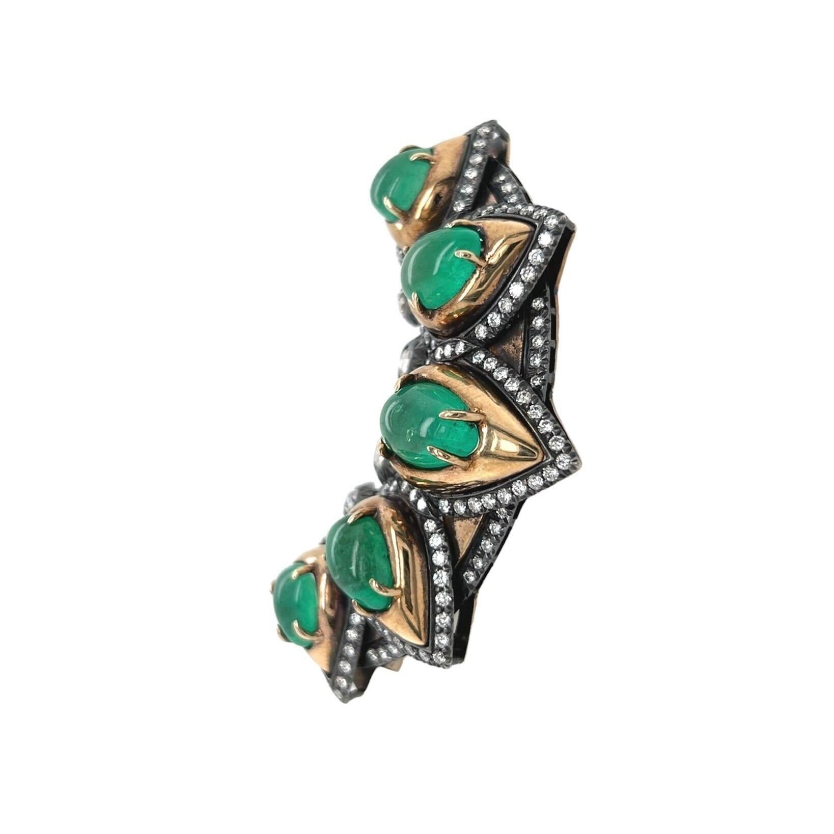 An 18 karat yellow gold, silver, emerald and diamond brooch, Marilyn Cooperman.  Designed as a crescent displaying five gold set pear shaped cabochon emeralds.  The emeralds and the crescent outlined with approimately one hundred sixty eight