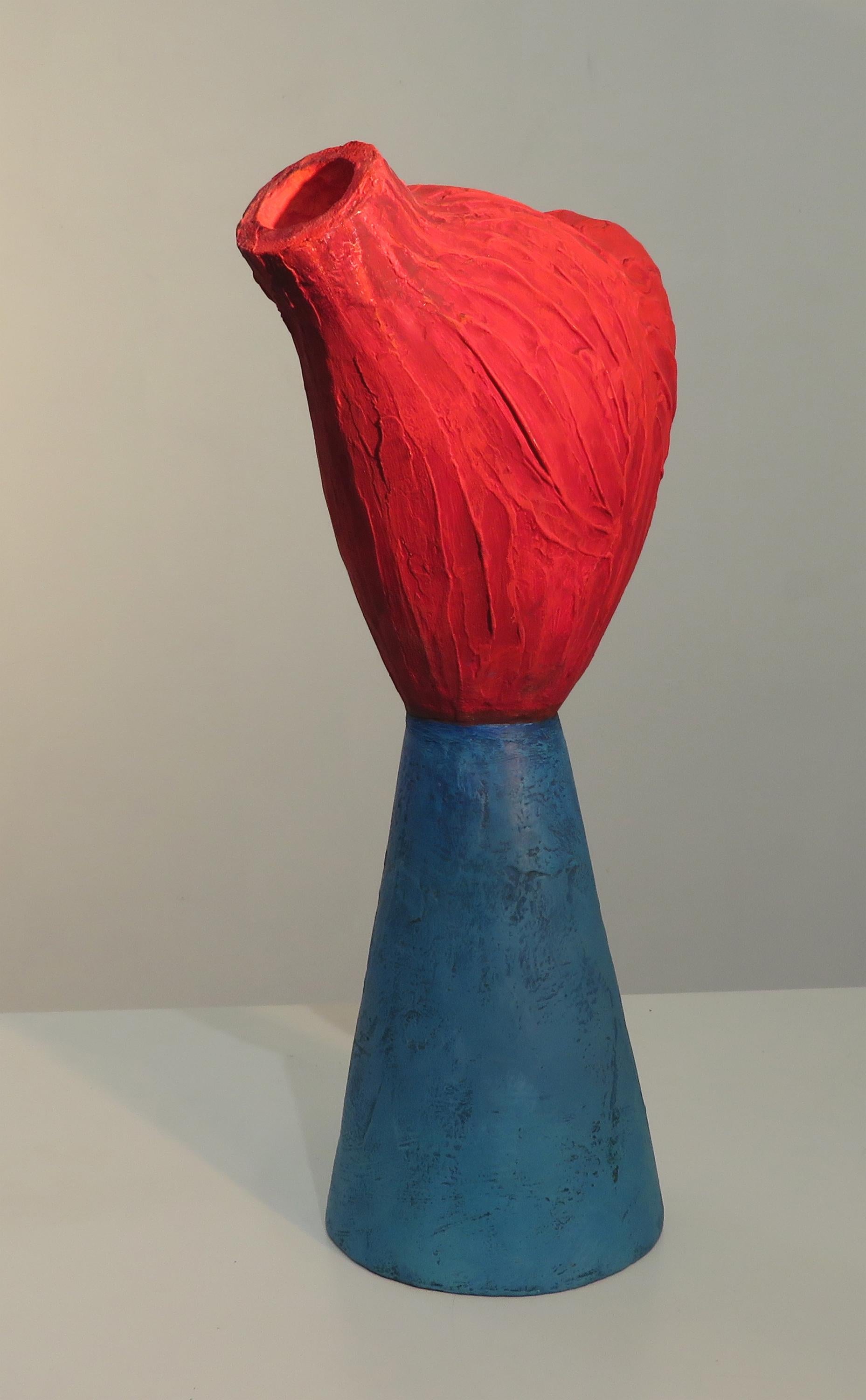 Paradox contemplates the conflicting passions of body, heart and mind in brilliant orange, red, blue and green. The artist’s work explores the marriage of painting and sculpture in this hybrid. Ambiguous yet familiar, it offers opportunity for