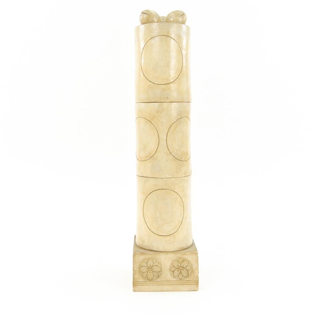 Marilyn Fox, American (20th century). 
White stoneware ceramic column sculpture, circa 1980s. Signed near base.
A witty feminine take on the age-old male form, this stoneware column features incised and relief-carved designs. Marilyn Fox is a