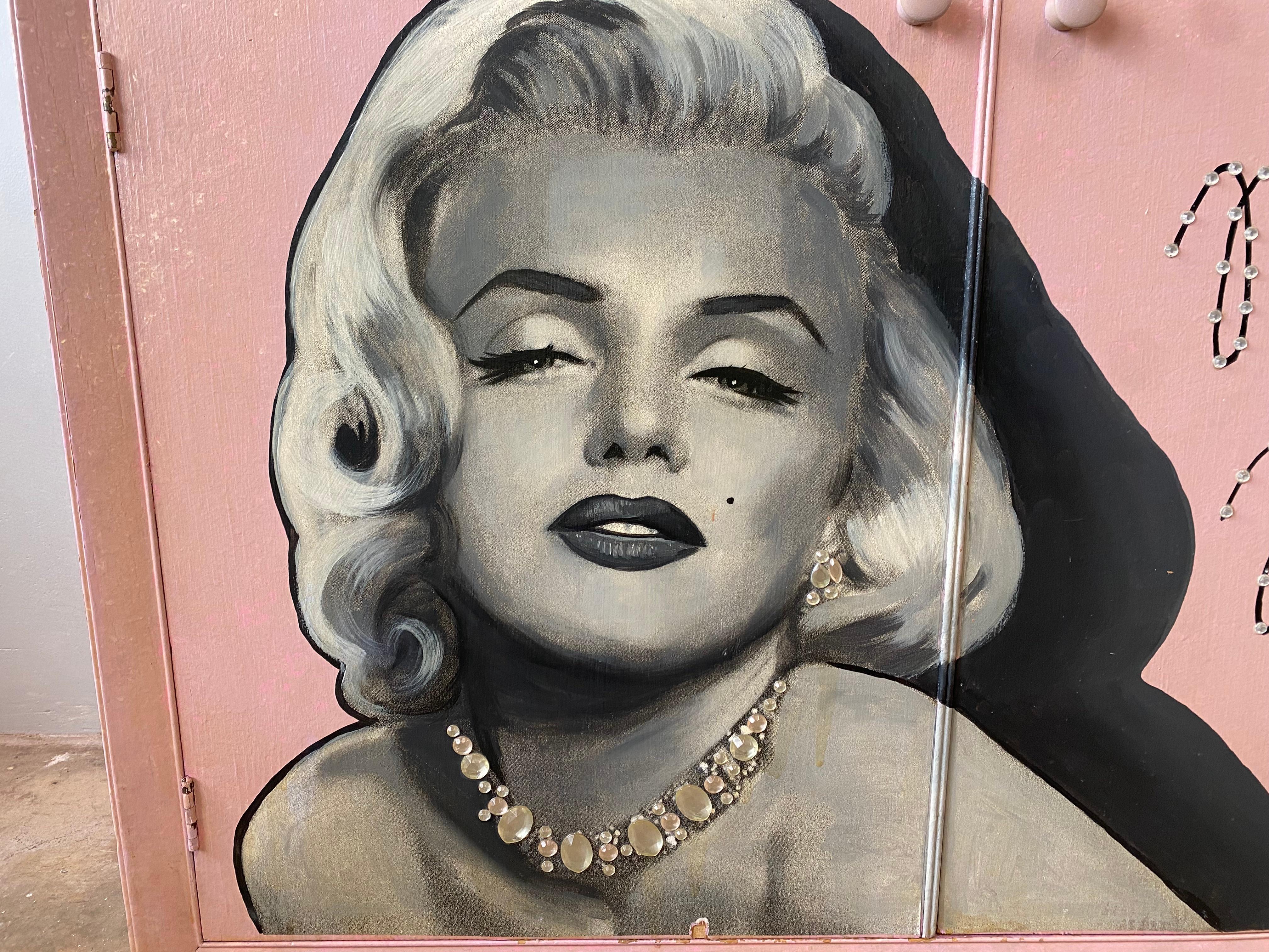 Unique pair of decorated Marilyn Monroe storage units. Includes a bookcase/bookshelf and a cabinet with drawer. Perfect for a beauty area, pink room, or garage decor. 

Slight wear and tear consistent with age but overall in good vintage condition