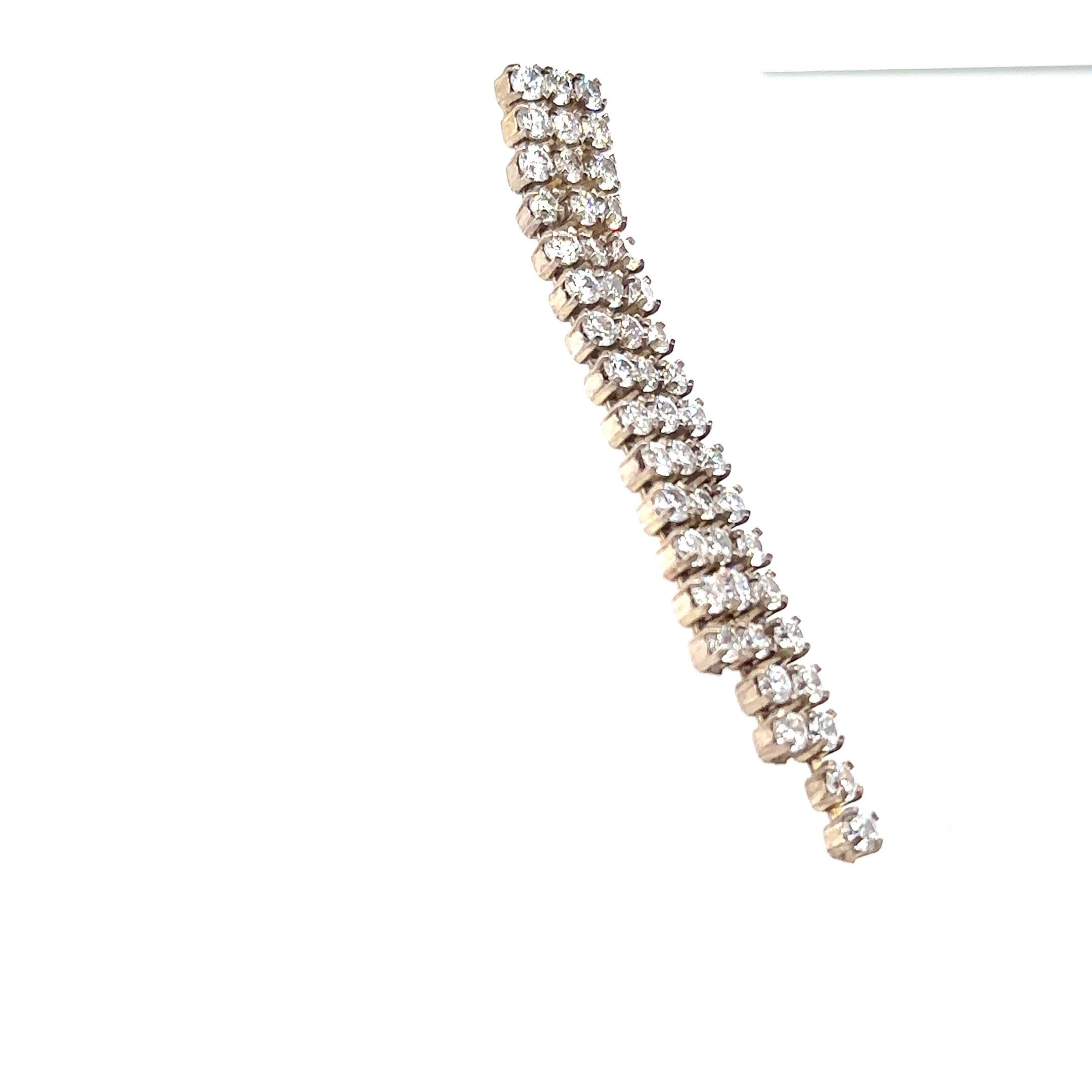 Post back earring of three strands of round prong set rhinestones. 
2 1/2 inches
Witness the undeniable allure of Marilyn Monroe as she graces the premiere of 