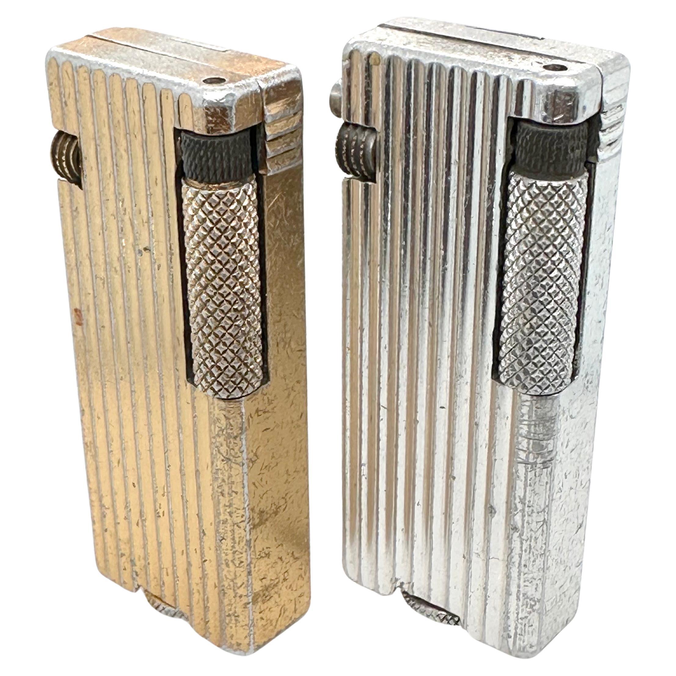 Two lighters on in gold metal the other in silver each engraved 