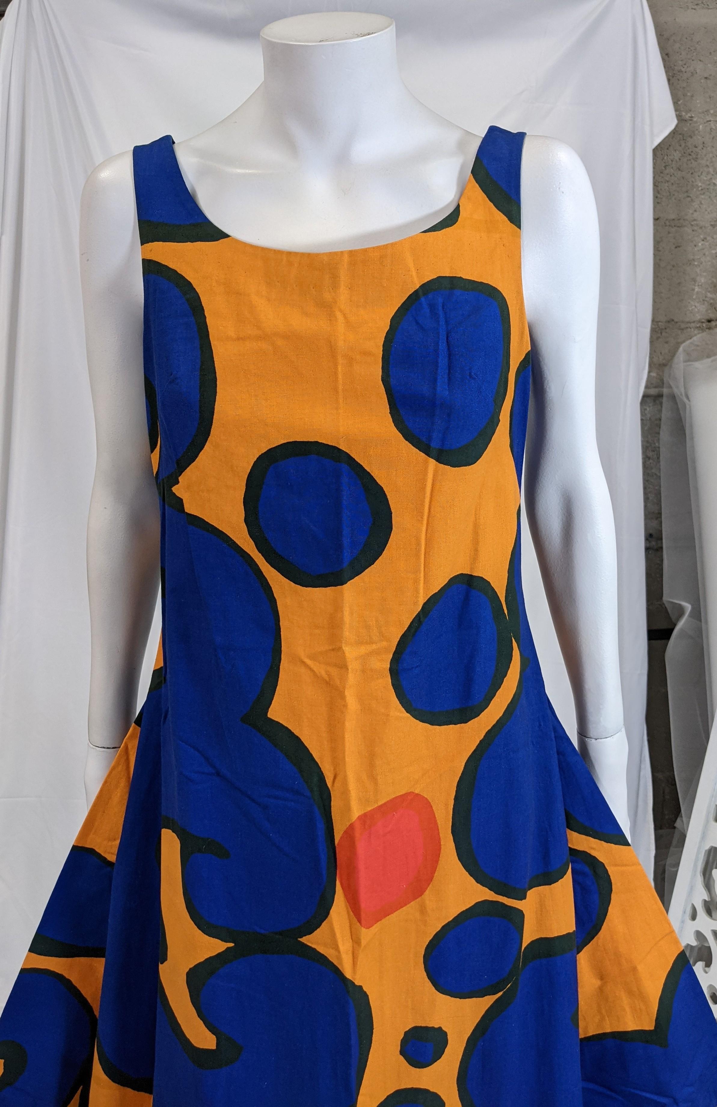 Unusual and striking  Marimekko Cotton Print Curved Hem Dress from the 1980s made in a crisp canvas with brightly colored abstracts with an unusual cut. The dress slips over the head with no closures and has long circular cut hem at front and back.