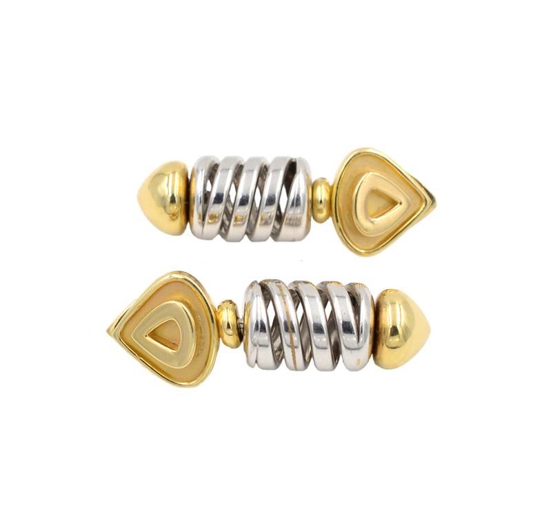 Marina B 18 karat yellow and white gold earring clips from circa 1980s.  The earrings feature a triangular yellow gold top on a white gold spiral and a yellow gold bottom. Marina B signed and numbered.
These earrings measure approximately 1.60
