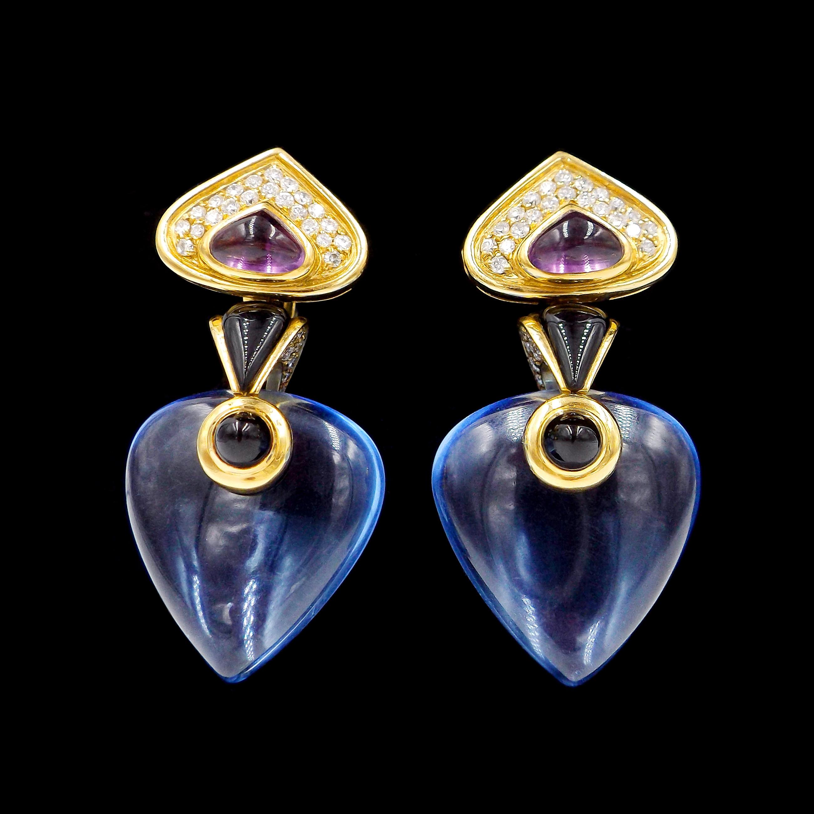Designed as diamond and amethyst earrings suspending a detachable diamond and onyx drop with interchangeable quartz beads
Metal: 18k yellow gold
Diamonds: 92 rounds diamonds with total weight of 1 carat
Stones: 2 cabochon amethysts, 6 carved