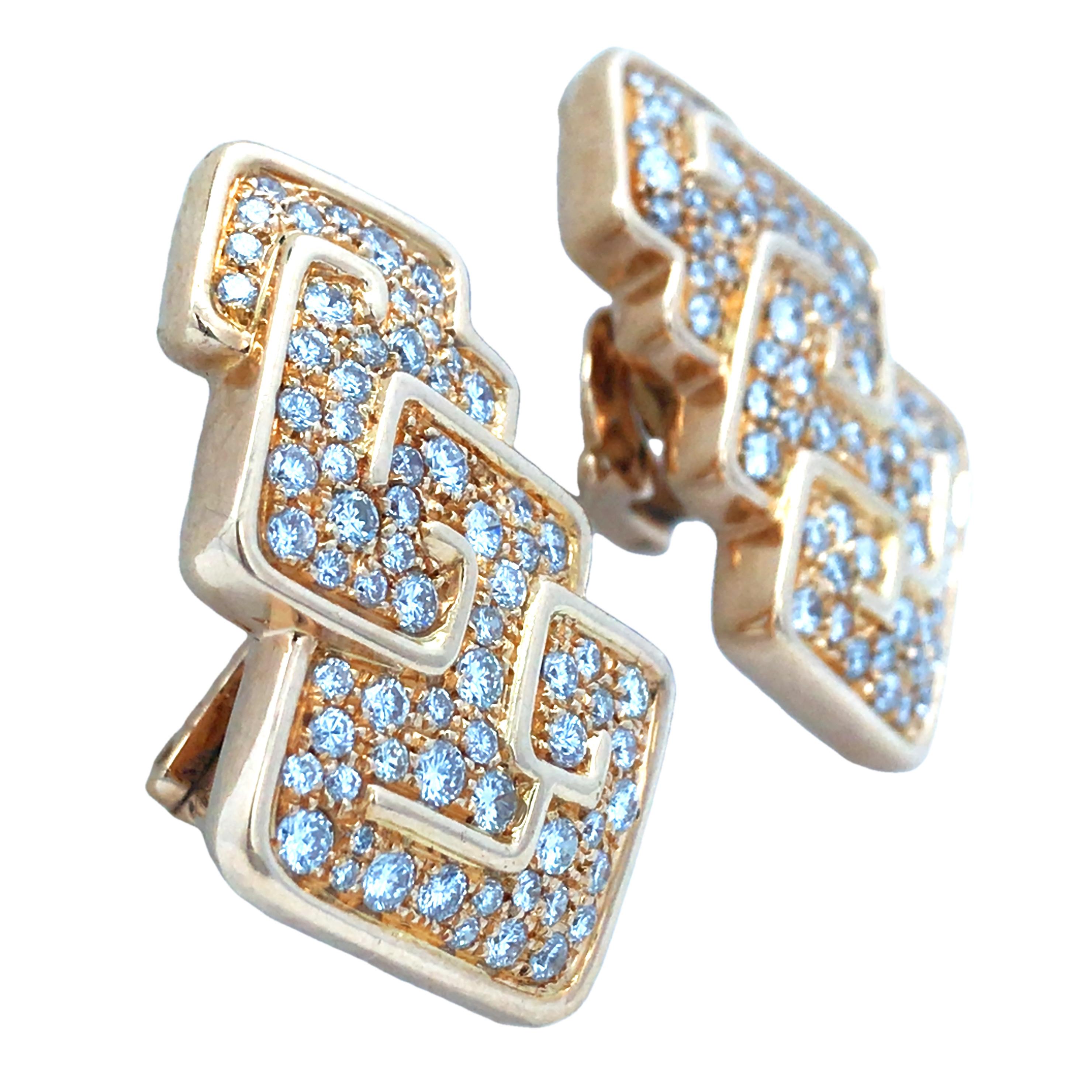 These Marina B 18K gold earrings redefine modern elegance with their bold geometric design. Adorned with approximately 4.2 carats of dazzling diamonds, they radiate a mesmerizing brilliance that catches every eye. Expert craftsmanship creates a
