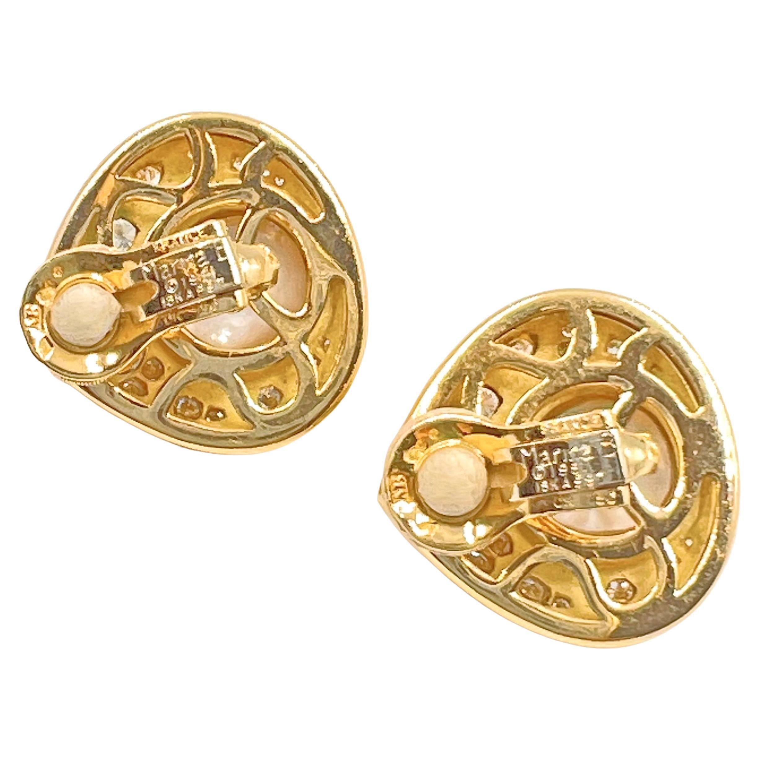 Pear-shaped polished 18k yellow gold earrings by Marina B.  Bezel-set with two larger mabe pearls measuring 12.5mm in diameter and each having a mother-of-pearl pear-shaped cabochon measuring 5 x 6mm at top.  Twenty-eight round brilliant-cut diamond
