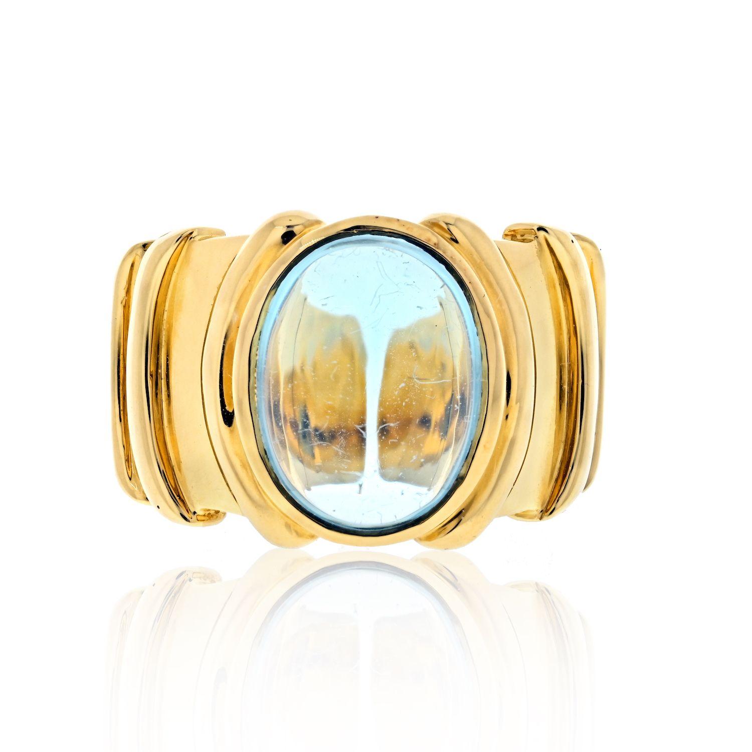 Marina B. 18K Yellow Gold Cabochon Topaz Ring.
18k gold ring by Marina B, with oval blue topaz cabochon (approx. 12.8mm x 10.7mm). Ring size 5.25, top of the ring is 16mm wide. Marked: Marina B.