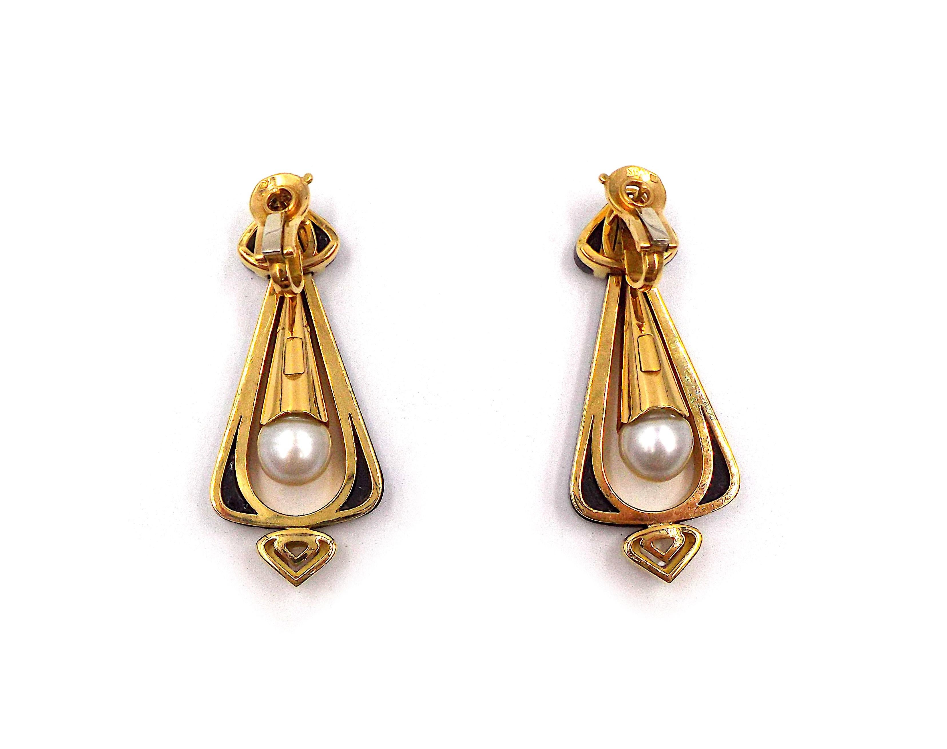 Each onyx set rounded triangular frame, with mother-of-pearl detail, enclosing a cultured pearl drop with mother-of-pearl set surmount, to spade shaped surmount with shaped onyx detail, clip fittings, French marks. With maker's mark MB, stamped