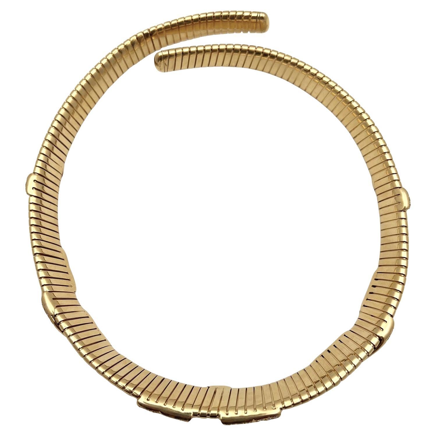 Marina B tubogas-style necklace, designed as a flexible spring link choker in polished 18k yellow gold accented by pavé-set diamond swag motifs. Round-cut diamonds weighing approximately 12.25 total carats. Clarity VVS-VS. Color E-F-G. The collar