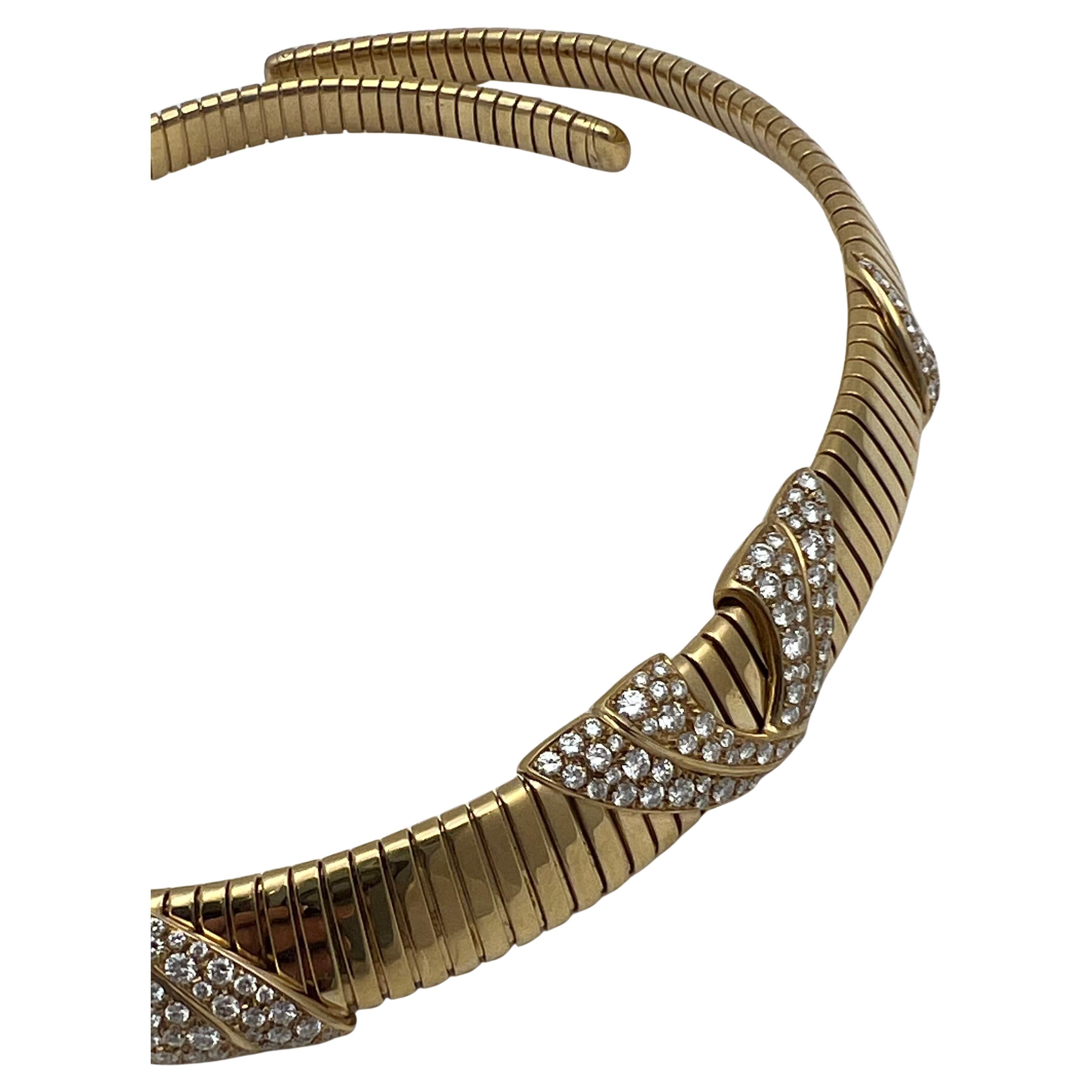 Marina B tubogas-style necklace, designed as a flexible spring link choker in polished 18k yellow gold accented by pavé-set diamond swag motifs. Round-cut diamonds weighing approximately 12.25 total carats (E-G color, VVS-VS clarity). Collar