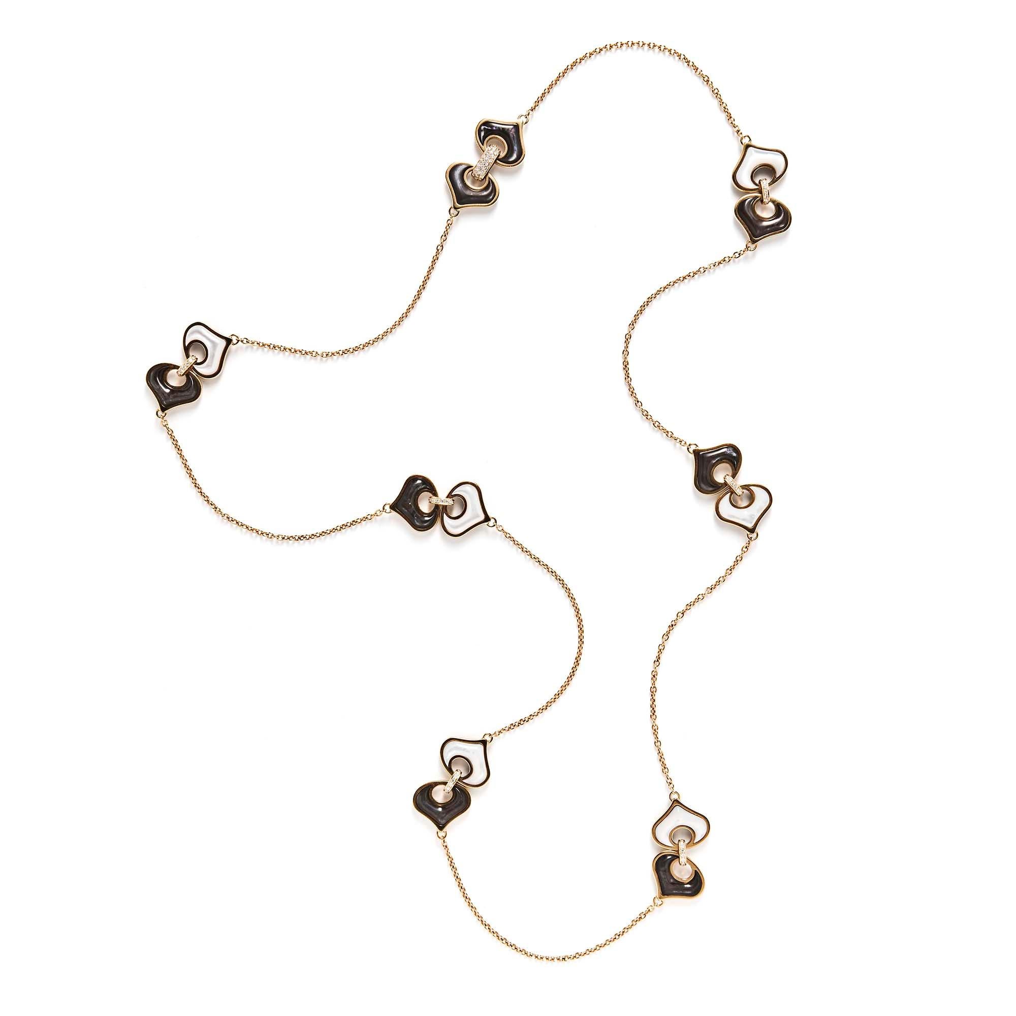 Marina B’s designs are characterized by a sense of refinement and ease. This classic oval link chain is spaced by seven pairs of fancy-shaped white and brown mother-of-pearl stations set within polished gold frames. They are joined by diamond-set