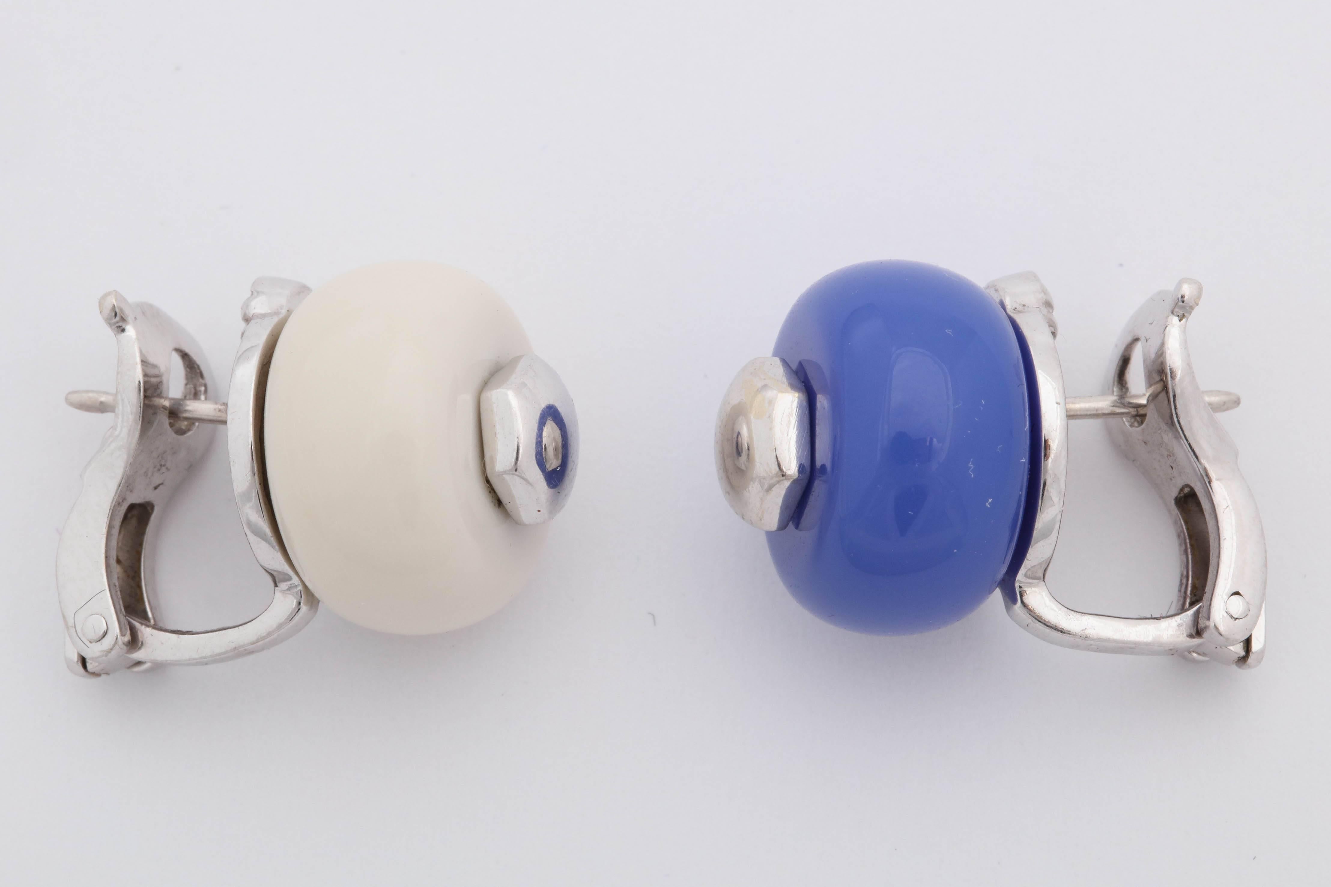 One Pair Of Ladies 18kt White Gold Earclips With Posts,Embellished With One blue Chaceldony Measuring approximately 12 MM And With One Circular Cut white agate Measuring approximately 12 MM . Each Stone Designed With One White Gold Stud