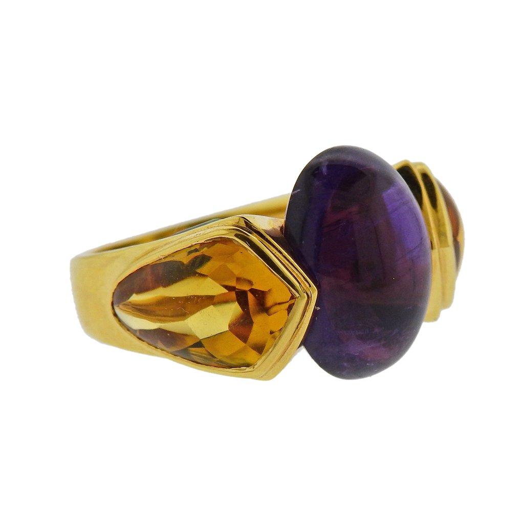18k yellow gold ring by Marina B, set with 16.1mm x 11.3mm amethyst cabochon, with citrines and peridots around. Ring size - 6.5, ring top is 16mm wide. Weight is 12.8 grams. Marked Marina B, MB, 179015, 750. 