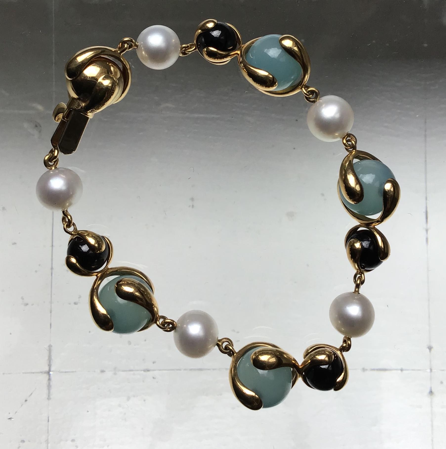 18-Karat Gold Cardan Bracelet with 28.32ct. Blue Chalcedony, 14.45 ct Black Jade, 15.15 ct. Pearl and 0.45 ct. Round Diamonds

Polished 18-karat yellow gold hardware and frame

Signed Marina B, Made in Italy and numbered 580072