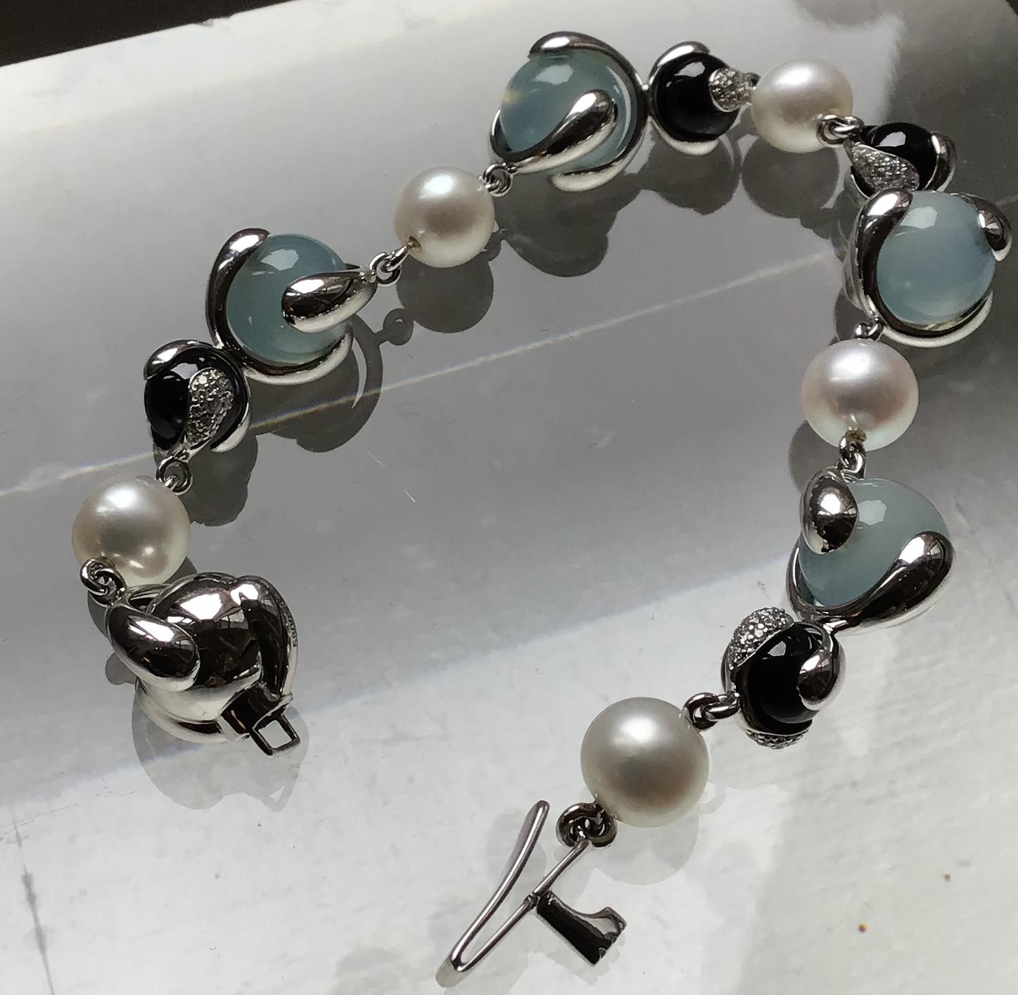 18-Karat Cardan Bracelet with 84.96ct Blue Chalcedony, 68.40ct Black Spinel, 54.54 ct Pearl Bead and 3.04ct Round Diamonds with box clasp closure.

Polished 18-karat white gold hardware and frame

Signed Marina B, Made in Italy and numbered 380063