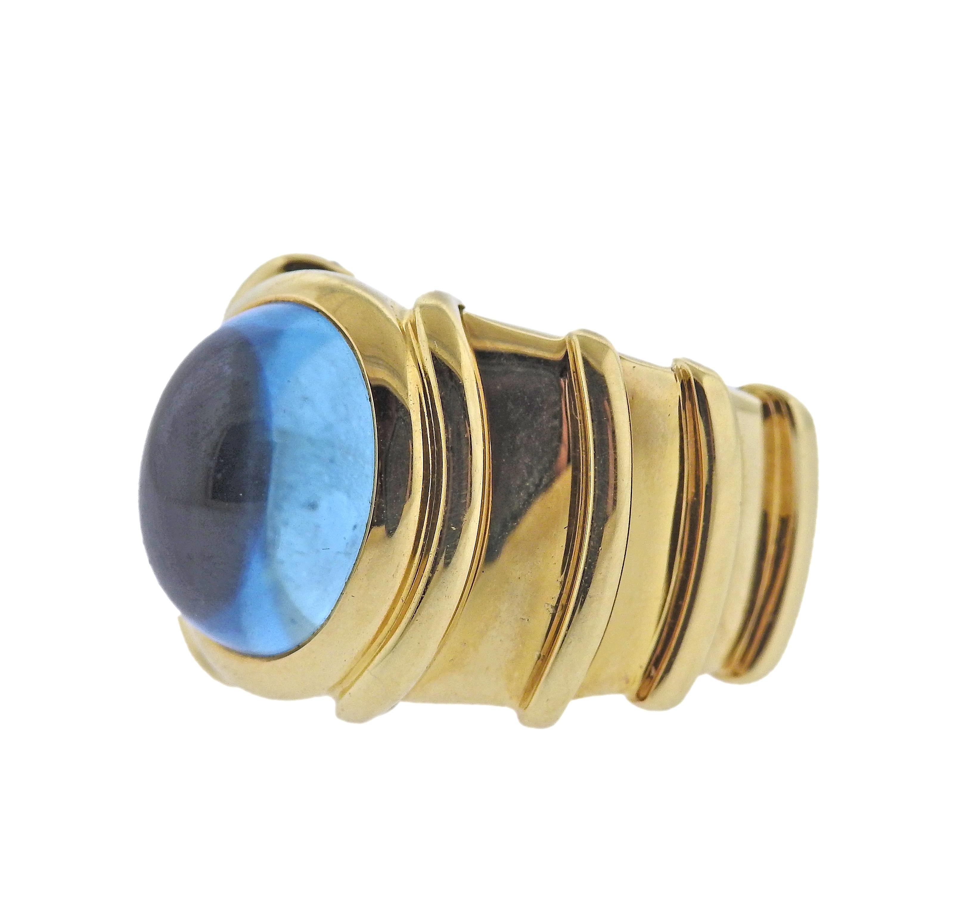 18k gold ring by Marina B, with oval blue topaz cabochon (approx. 12.8mm x 10.7mm). Ring size 5, top of the ring is 16mm wide. Marked: Marina B, AA61, MB, 750. Weight - 20.7 grams.