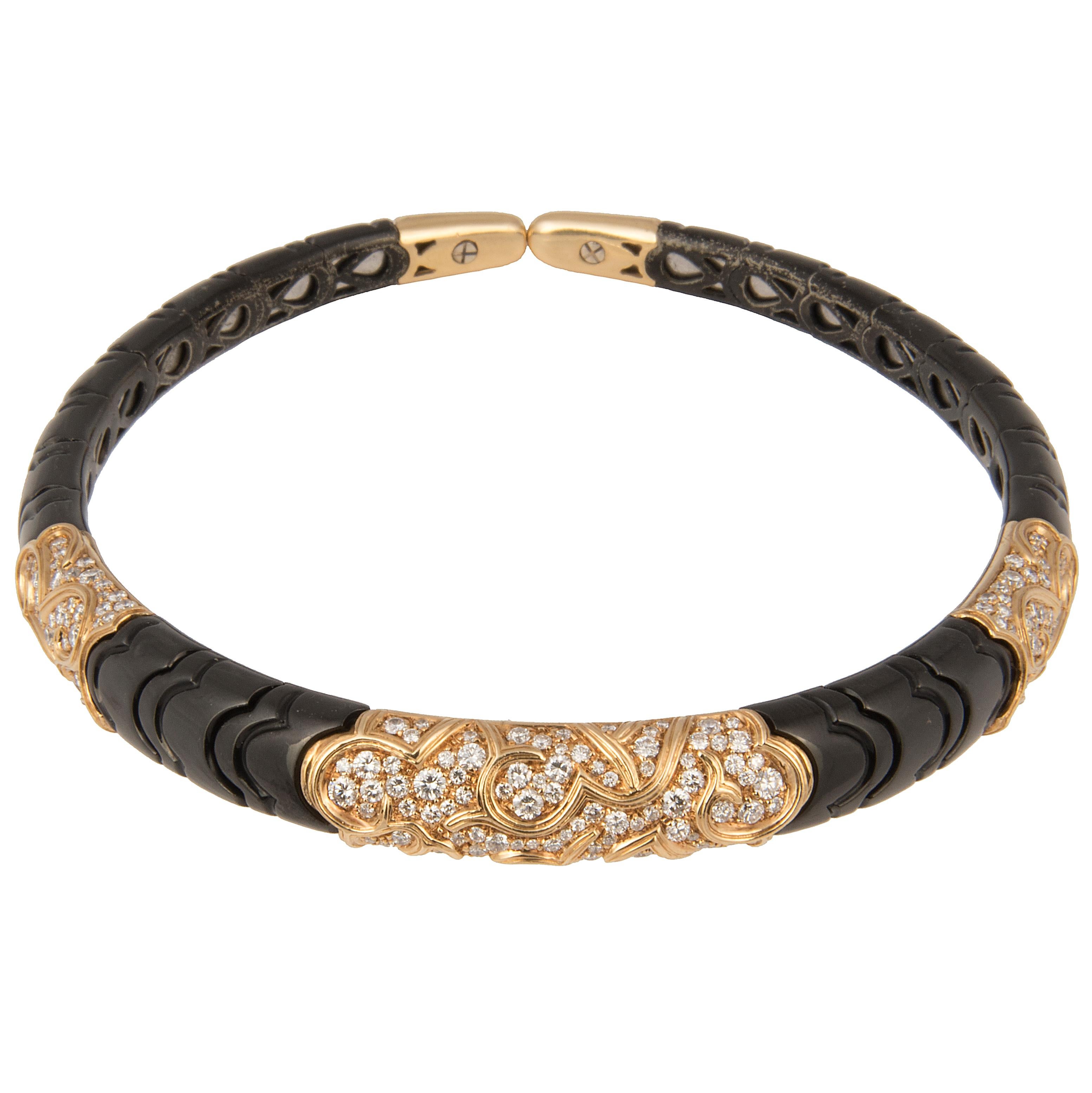 Marina B choker necklace 'Onda', 18k yellow gold and black gold on a steel spring, decorated with three pavé set diamonds motifs.
Signed Marina B, markers mark, Italian hallmarks, numbered C1460.
Circa 1978

The Onda collection was created in 1978.