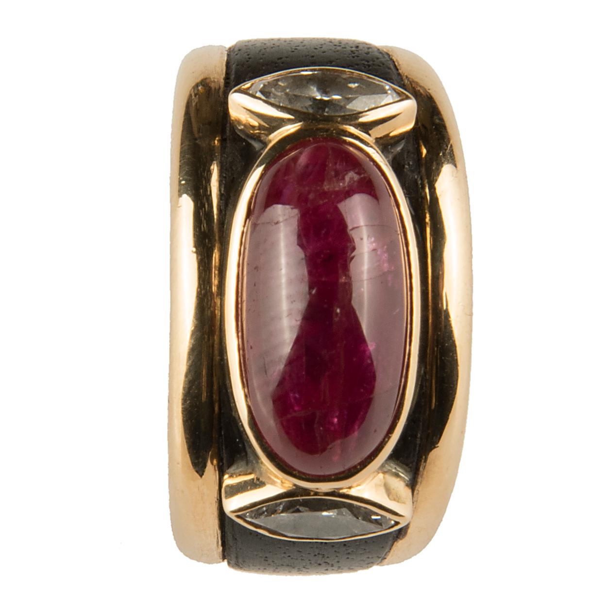 Stylish ring by Marina B (Bulgari), the 18k yellow gold band inlaid with black patinated wood, centred by an oval cabochon ruby and two marquise diamonds
Signed Marina B, maker's mark, French hallmarks and numbered 15/127
Ring size EU: 50-51, US: